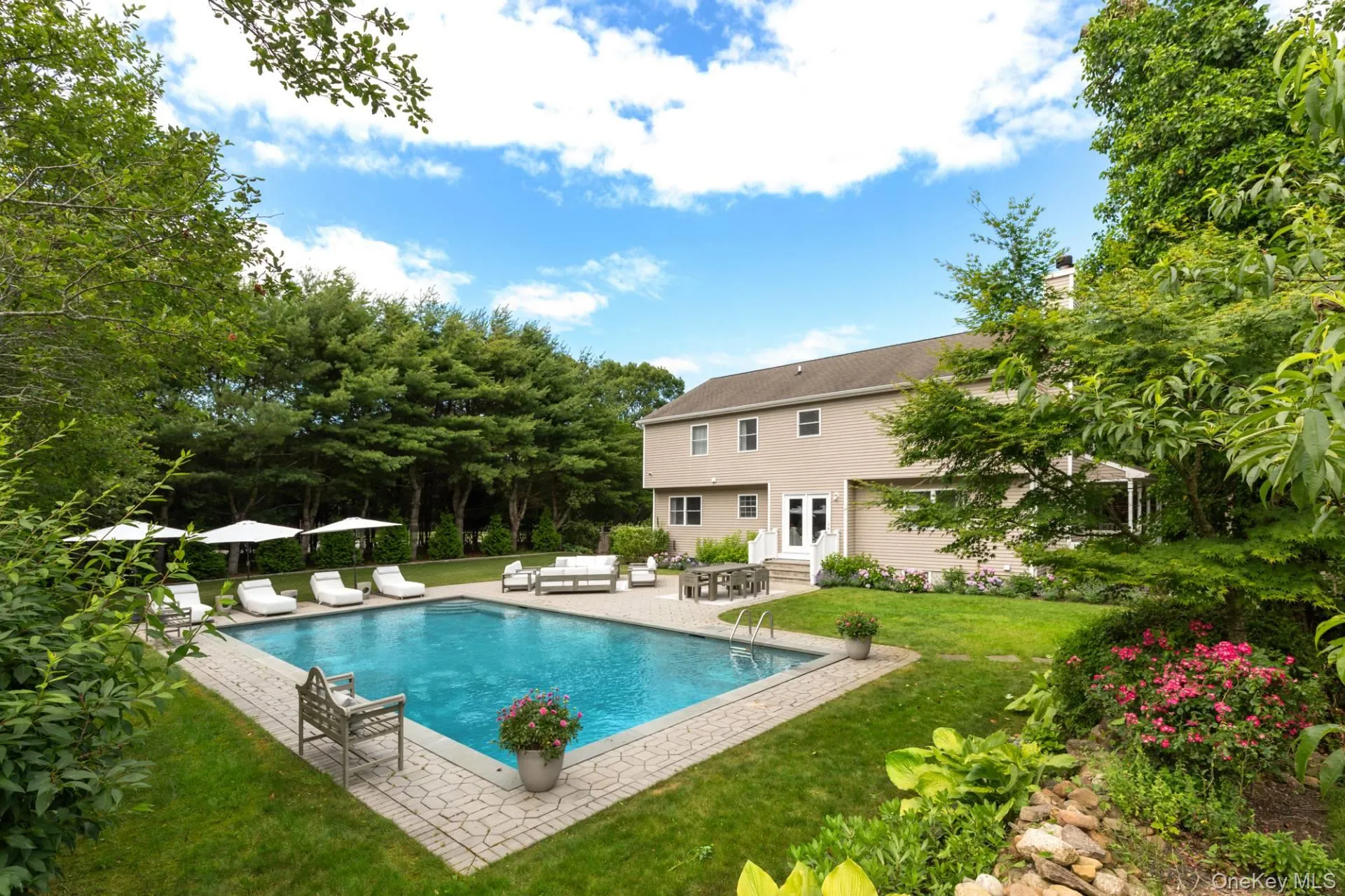 Swimming pool with a yard, a patio area, entry steps, and an outdoor living space Swimming pool with a yard, a patio area, entry steps, and an outdoor living space
