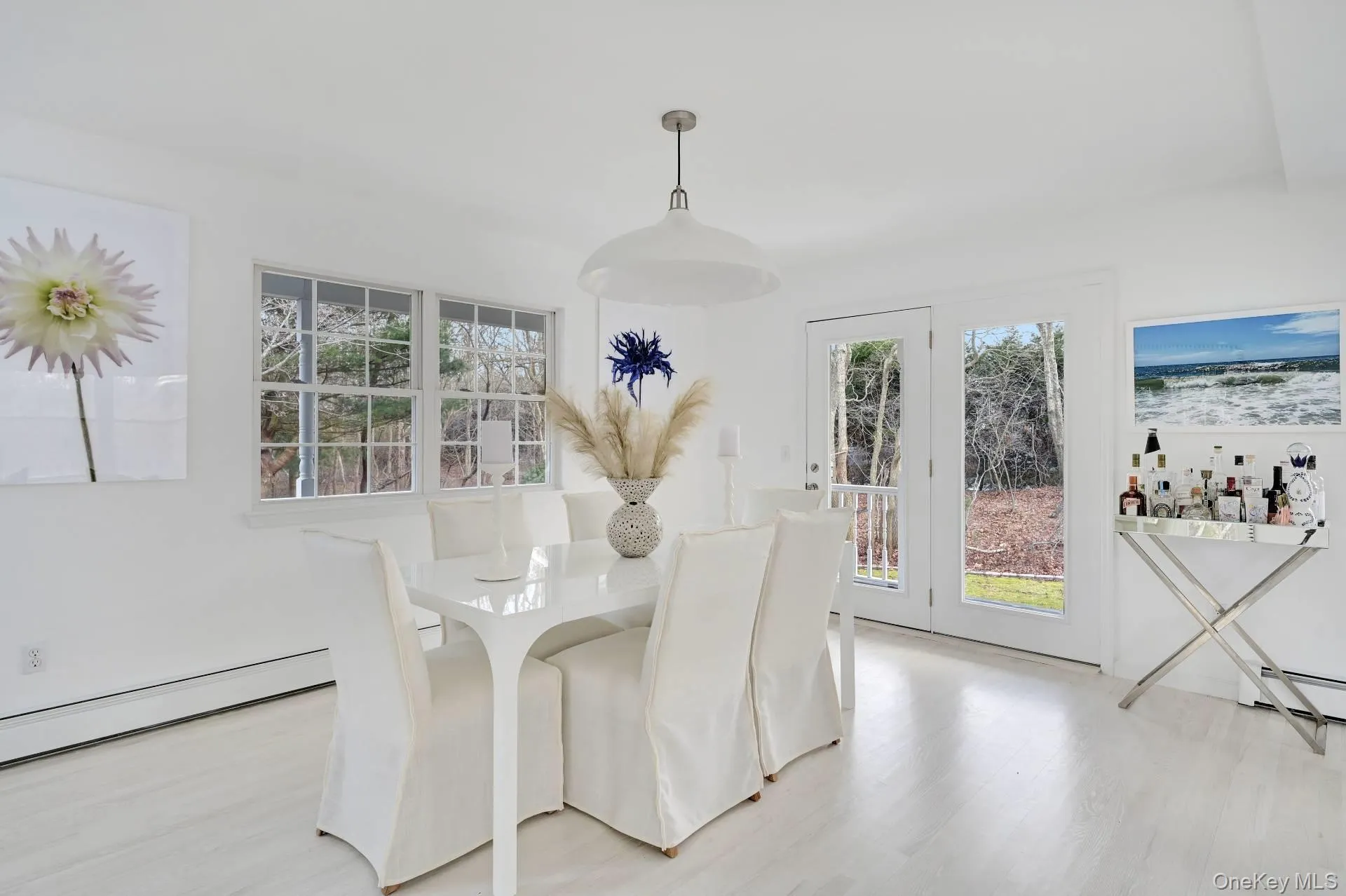 Dining space with light wood-style floors and a baseboard radiator Dining space with light wood-style floors and a baseboard radiator