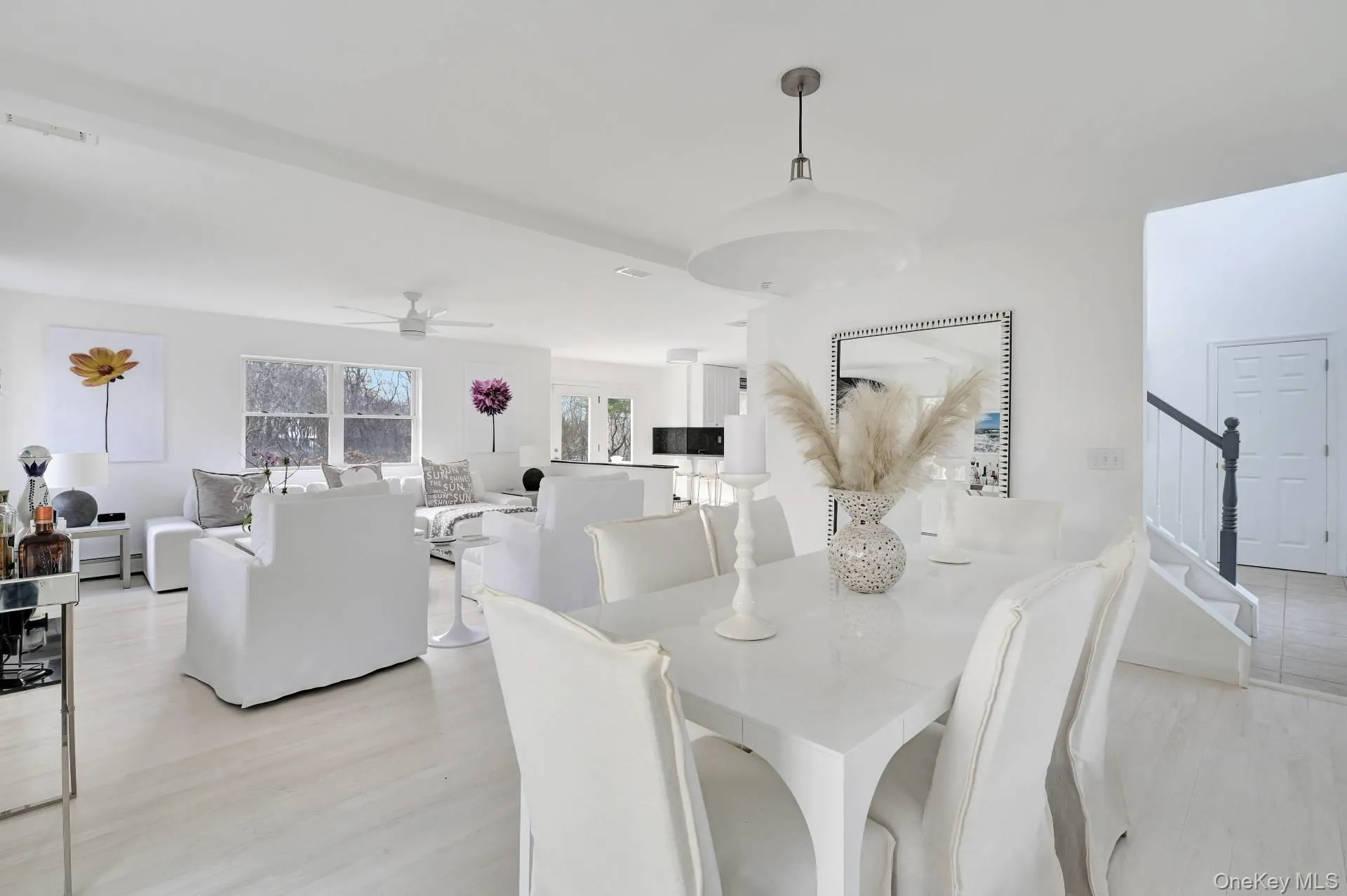 Dining space with light wood-style floors, stairway, and a ceiling fan Dining space with light wood-style floors, stairway, and a ceiling fan