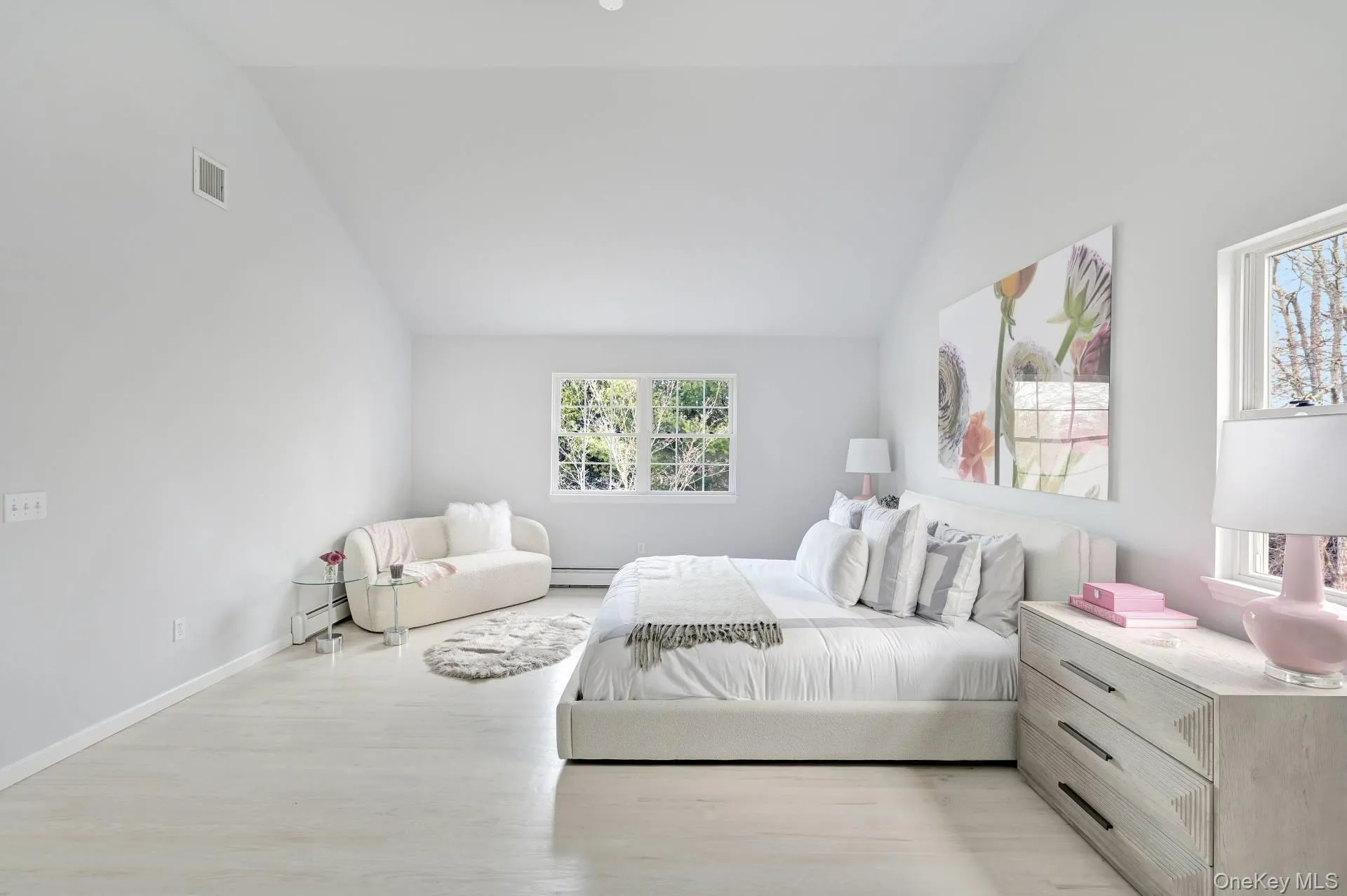 Bedroom featuring light wood-type flooring, a baseboard radiator, and high vaulted ceiling Bedroom featuring light wood-type flooring, a baseboard radiator, and high vaulted ceiling