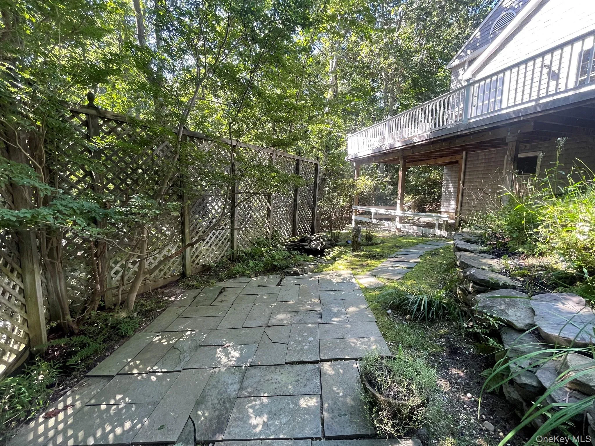 Fenced backyard featuring a wooden deck Fenced backyard featuring a wooden deck