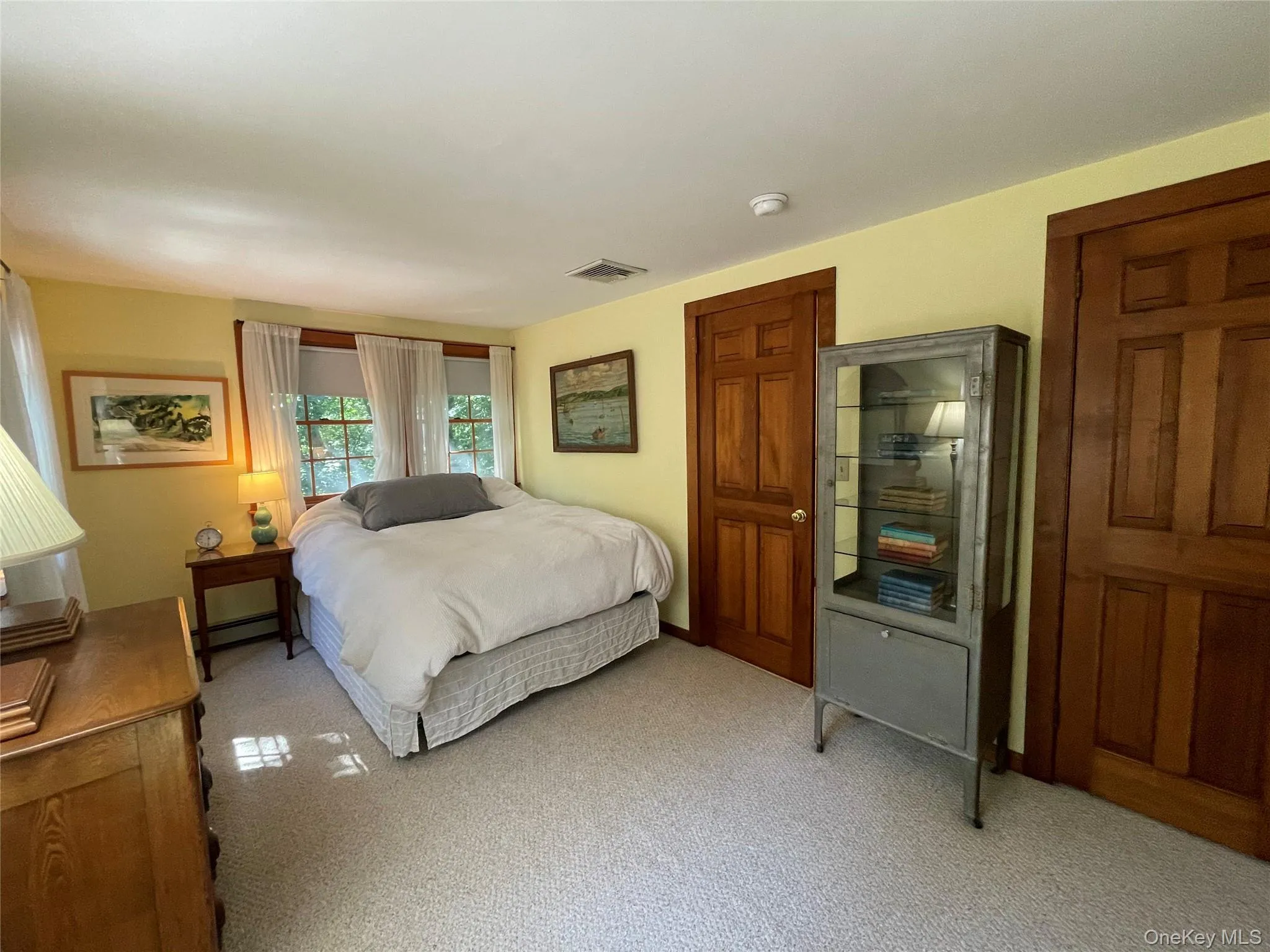 Bedroom featuring carpet and a baseboard radiator Bedroom featuring carpet and a baseboard radiator