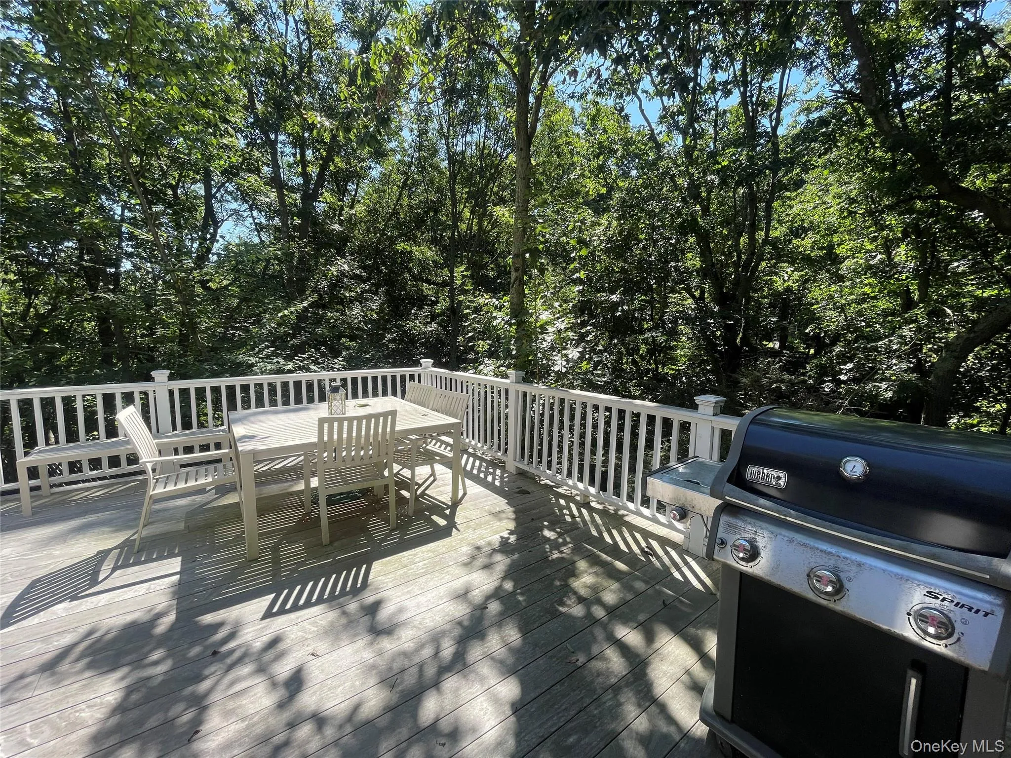 Wooden deck featuring a grill and outdoor dining area Wooden deck featuring a grill and outdoor dining area