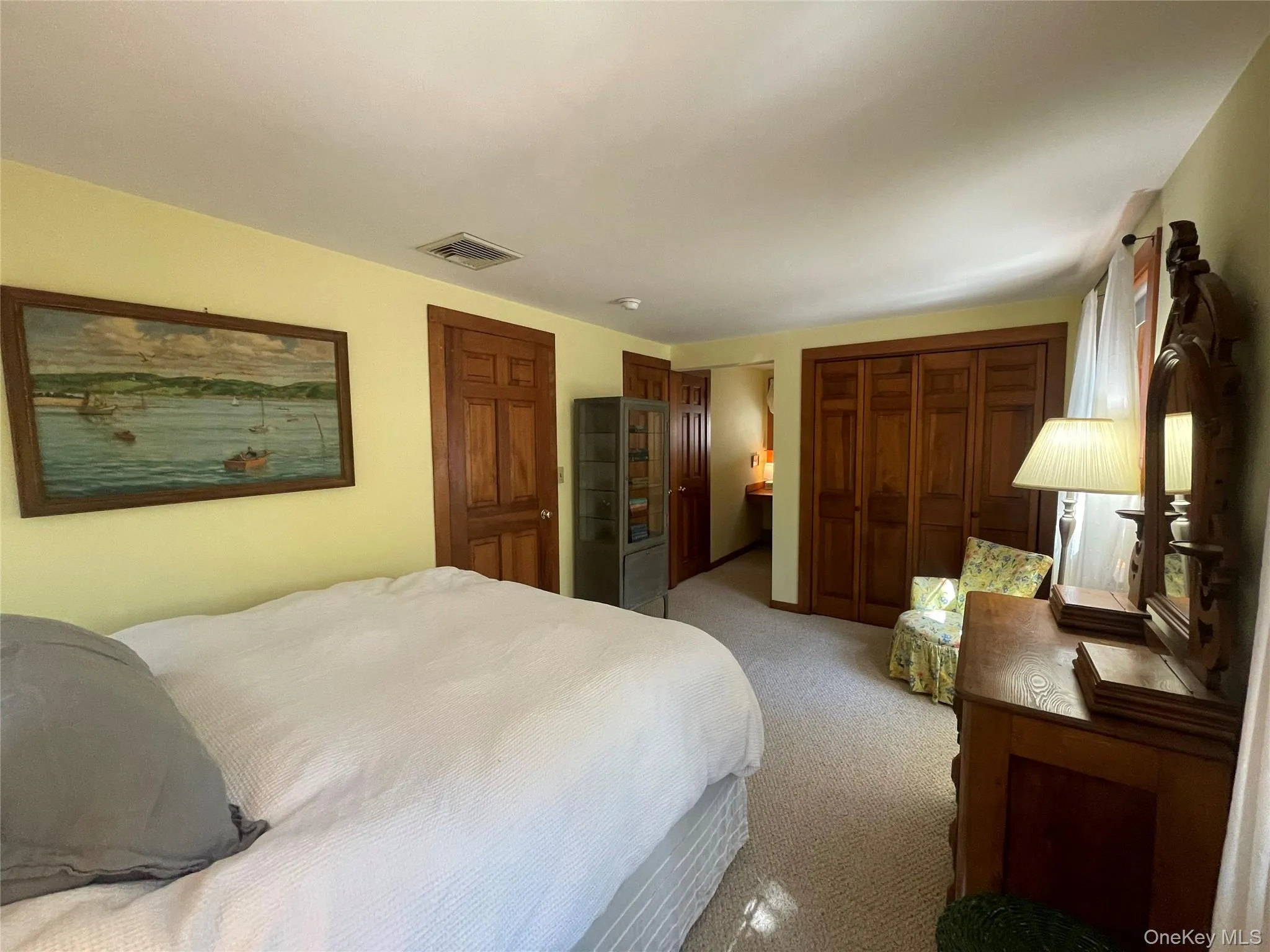 Bedroom featuring multiple closets and carpet Bedroom featuring multiple closets and carpet