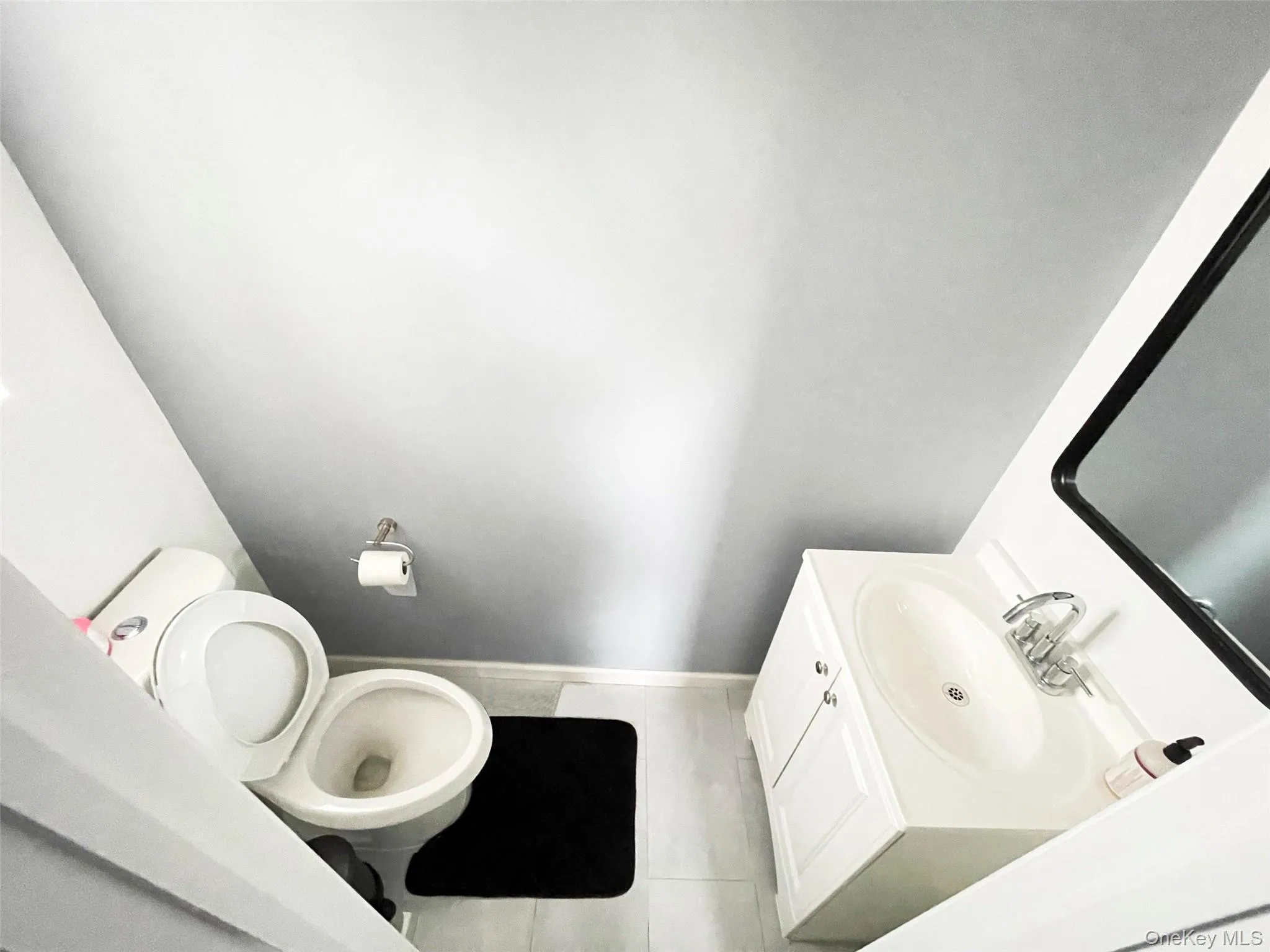 Bathroom with vanity and light tile patterned flooring Bathroom with vanity and light tile patterned flooring