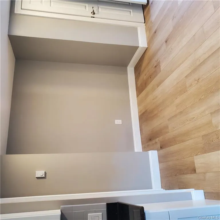 Unfurnished room with baseboards and light wood-style floors Unfurnished room with baseboards and light wood-style floors