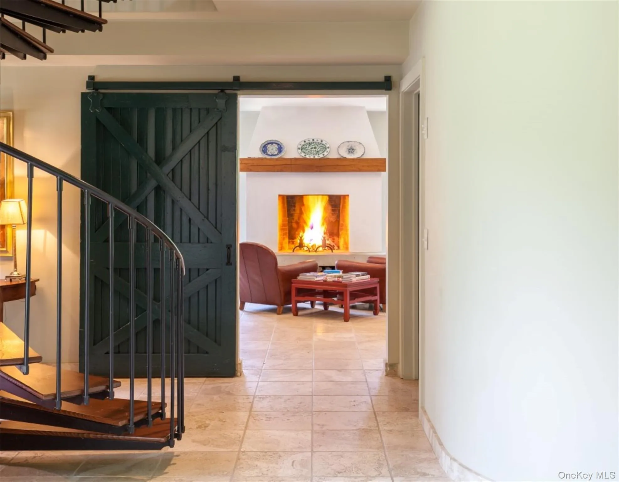 Hallway featuring a barn door and stairs Hallway featuring a barn door and stairs