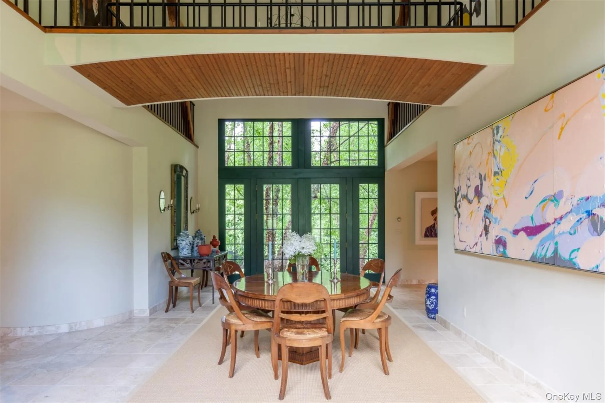 Dining area with a high ceiling and baseboards Dining area with a high ceiling and baseboards