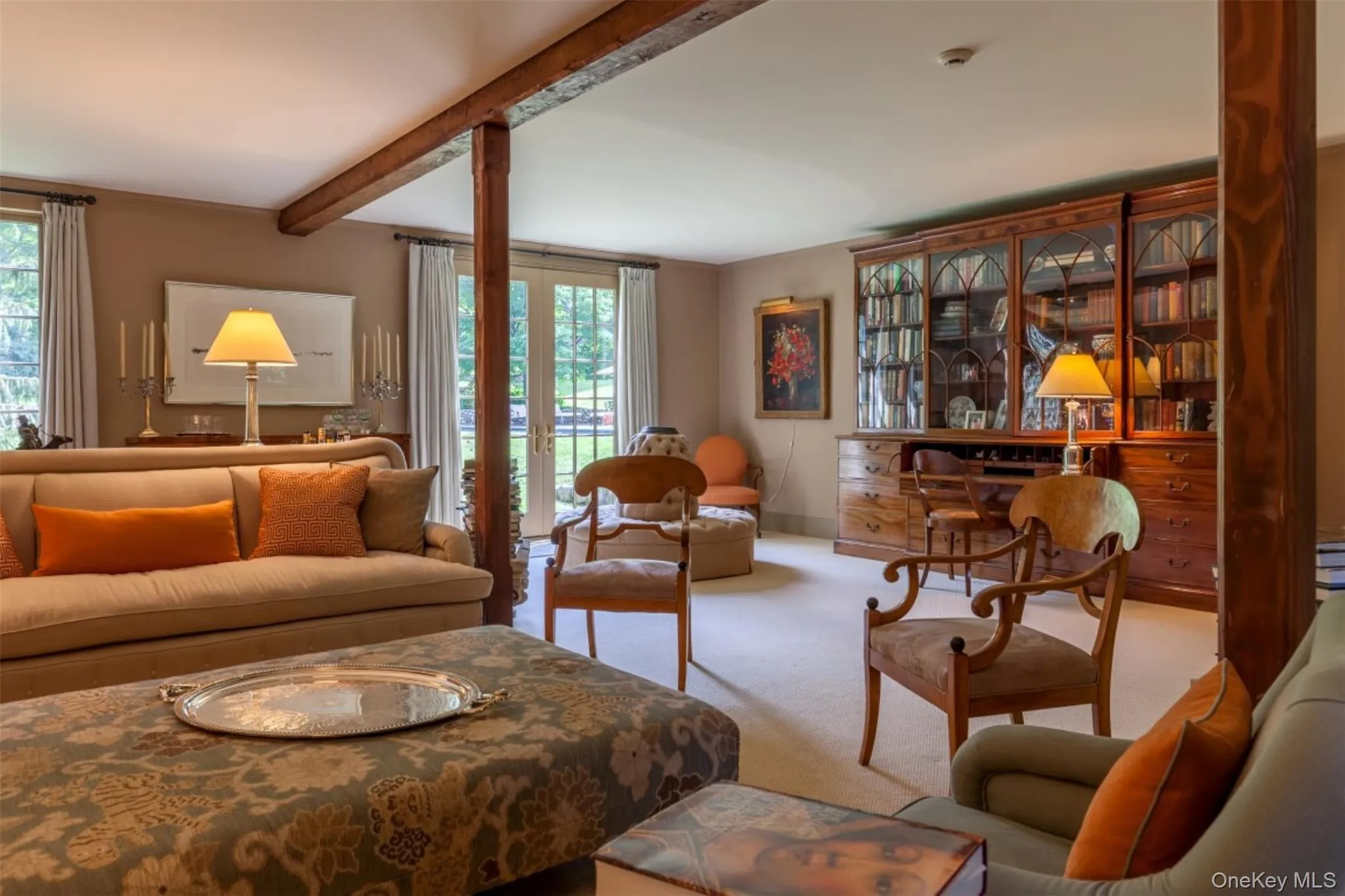 Carpeted living area featuring beamed ceiling Carpeted living area featuring beamed ceiling