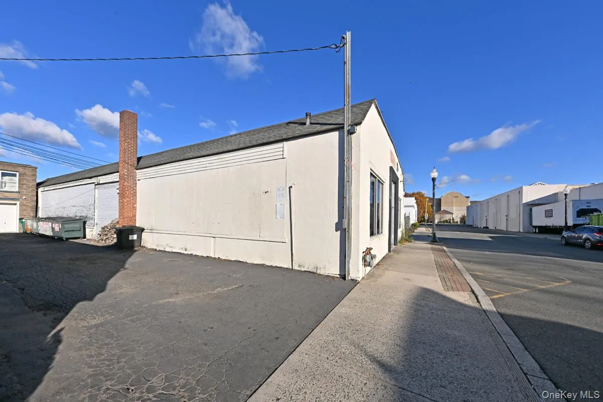 View of side of home with a shingled roof View of side of home with a shingled roof