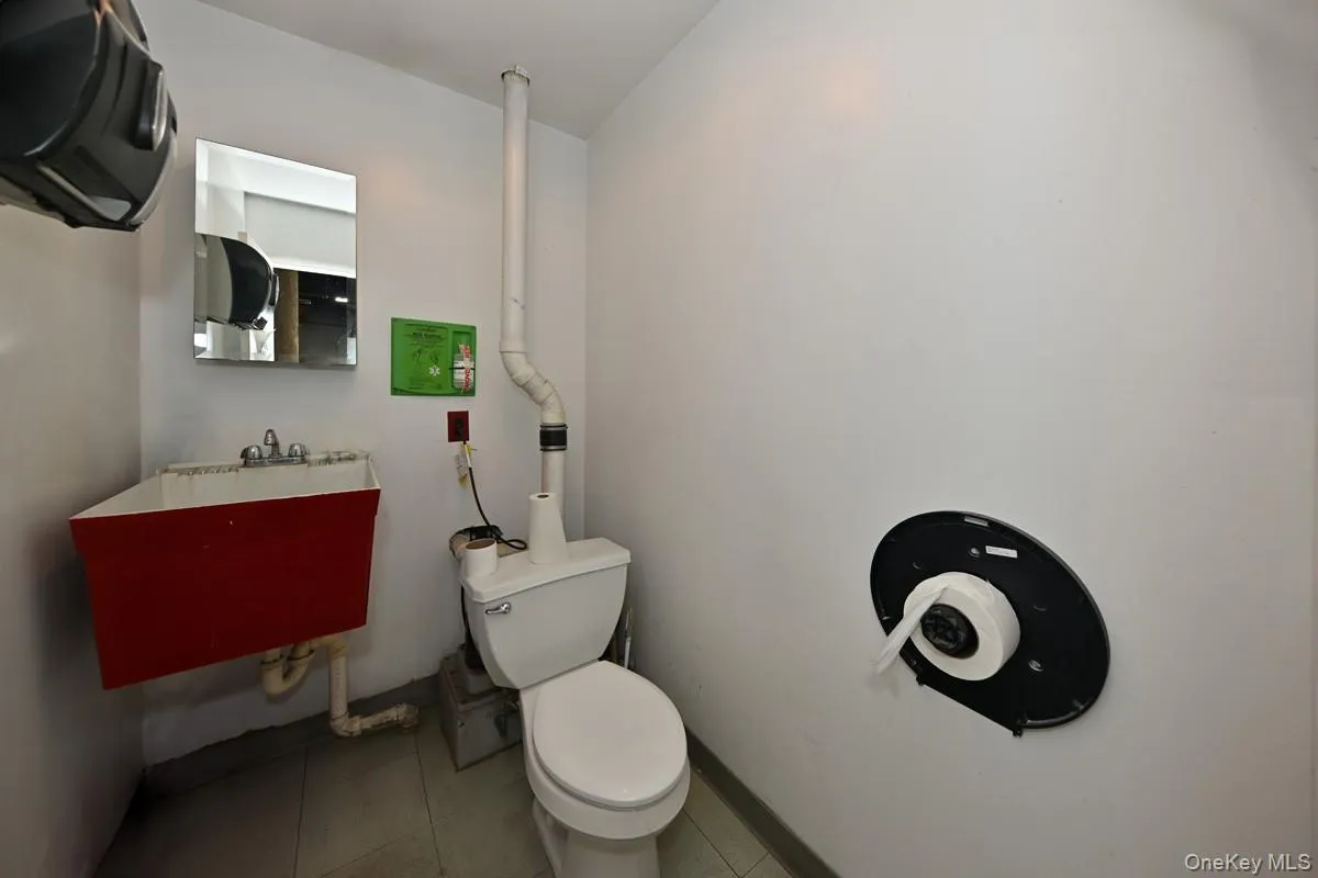 Half bath featuring tile patterned flooring Half bath featuring tile patterned flooring