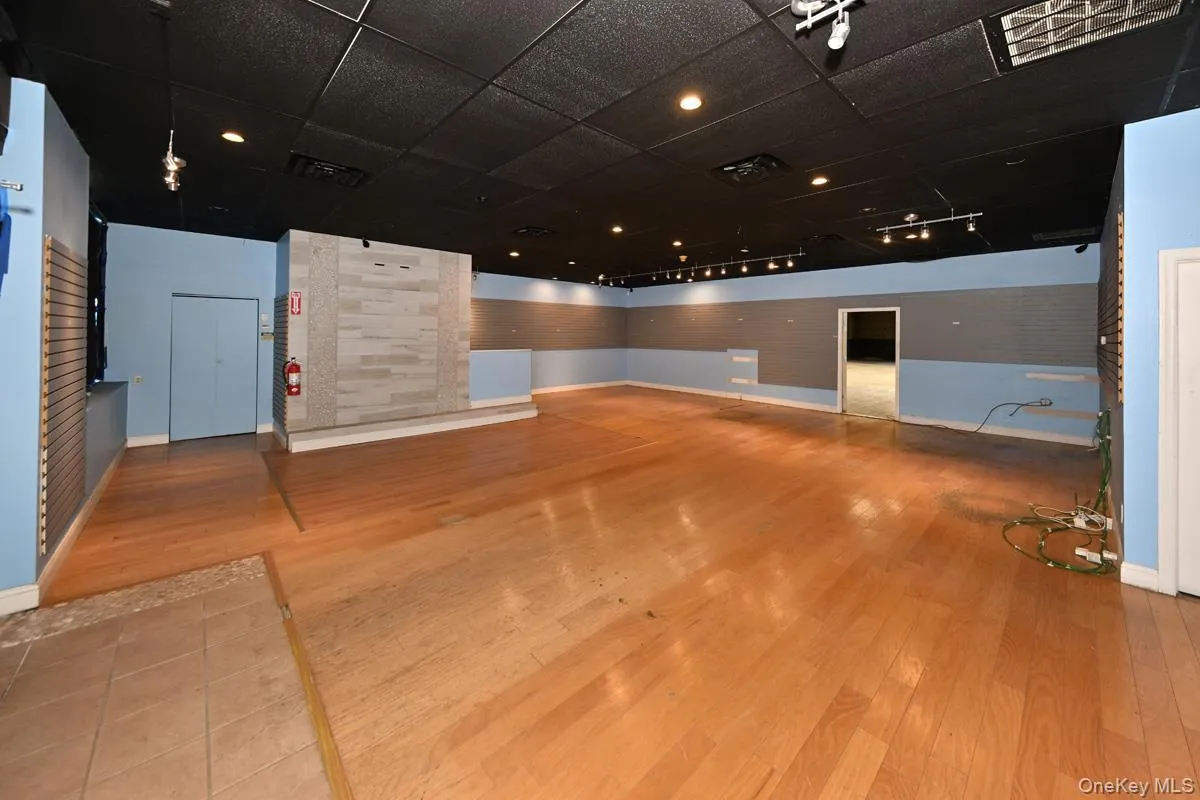 Spare room with light wood finished floors and a drop ceiling Spare room with light wood finished floors and a drop ceiling