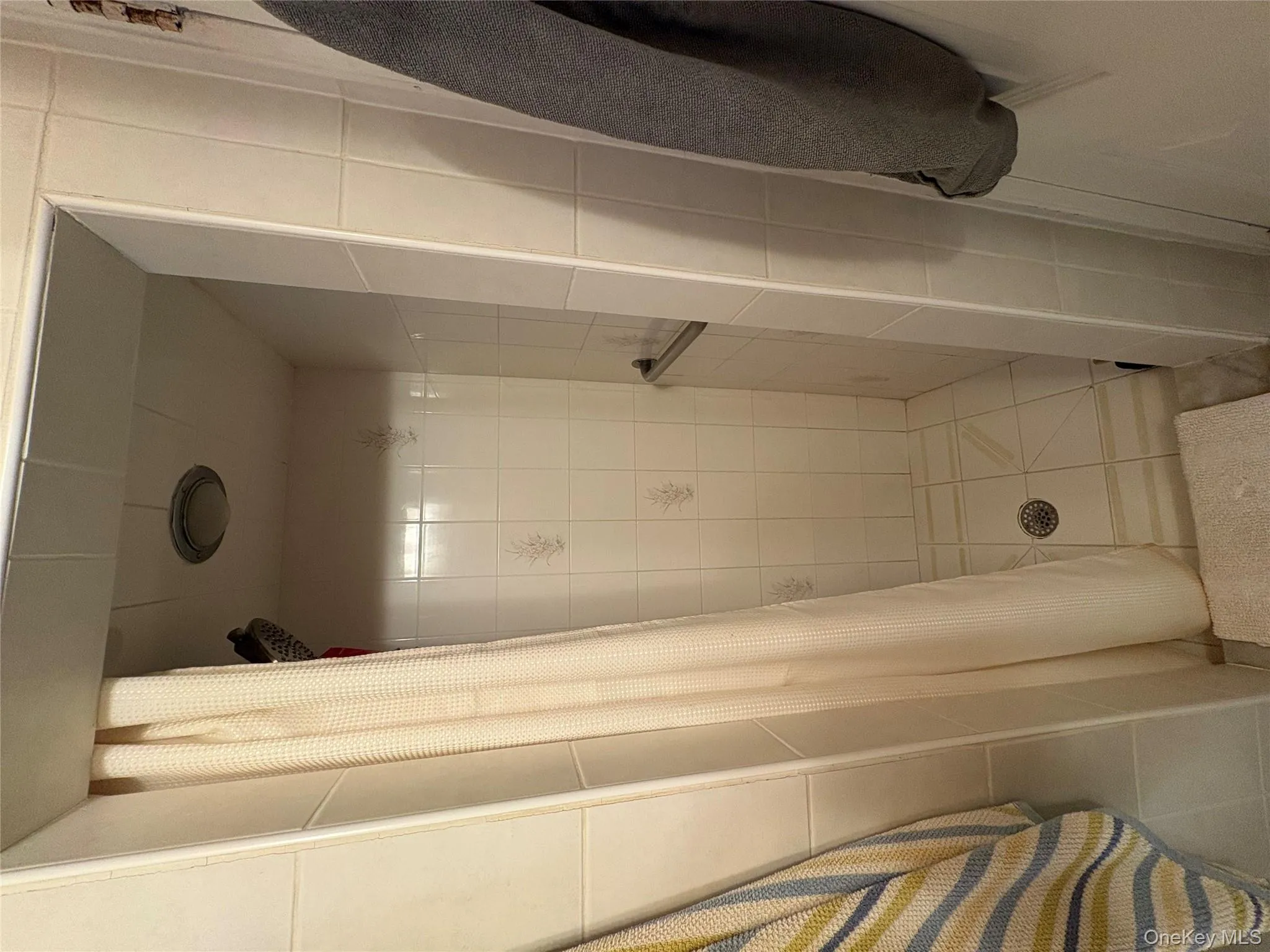 Full bath featuring a shower stall Full bath featuring a shower stall