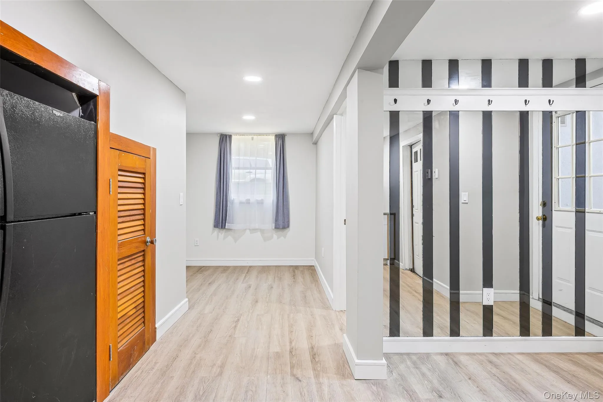 Hallway featuring light wood-style flooring and recessed lighting Hallway featuring light wood-style flooring and recessed lighting