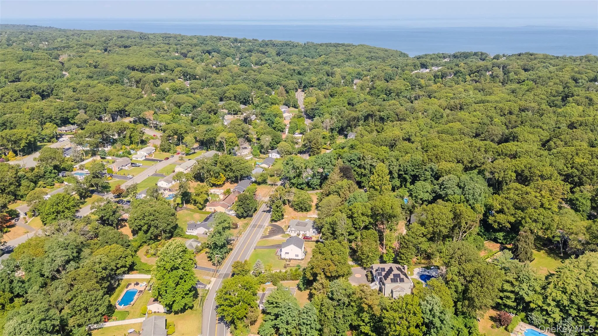 Aerial perspective of suburban area featuring a forest Aerial perspective of suburban area featuring a forest