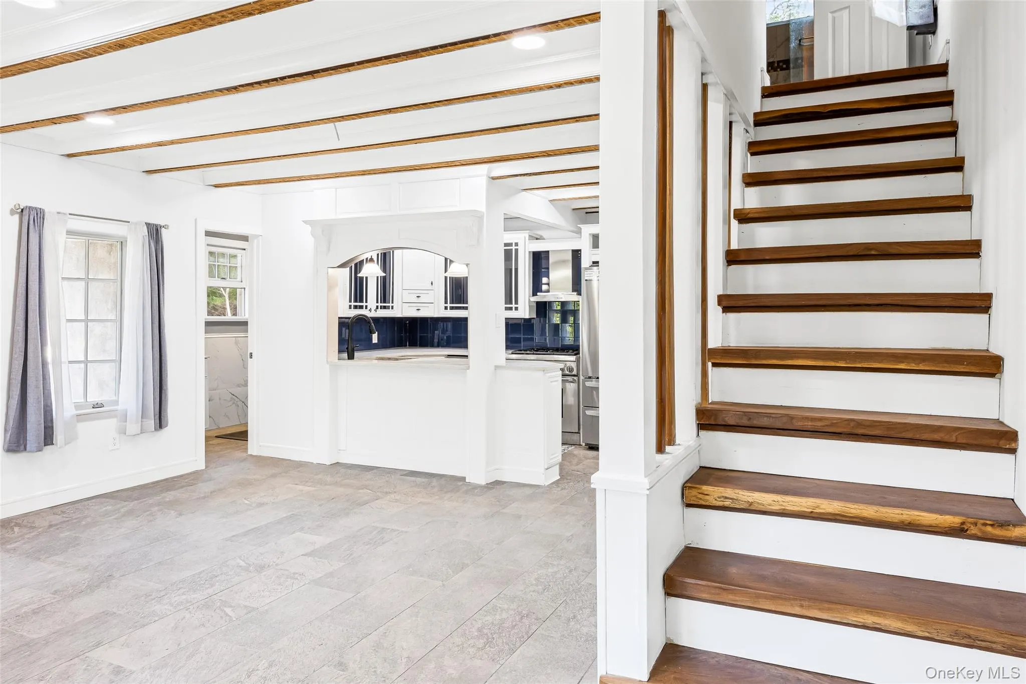 Staircase with beamed ceiling and baseboards Staircase with beamed ceiling and baseboards