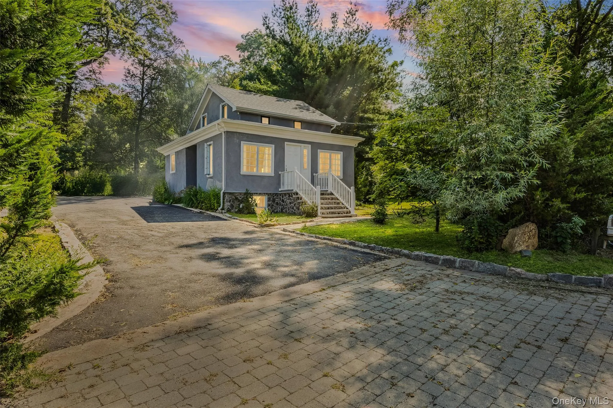 View of front of home with stucco siding and driveway View of front of home with stucco siding and driveway