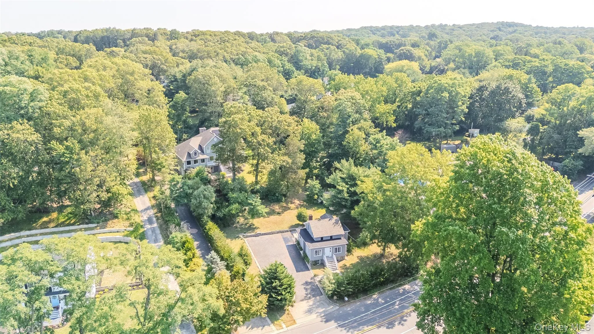 Aerial overview of property's location with a forest Aerial overview of property's location with a forest