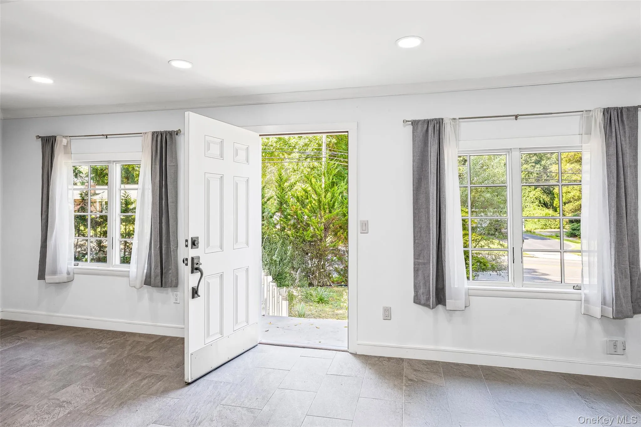 Doorway to outside featuring baseboards and recessed lighting Doorway to outside featuring baseboards and recessed lighting