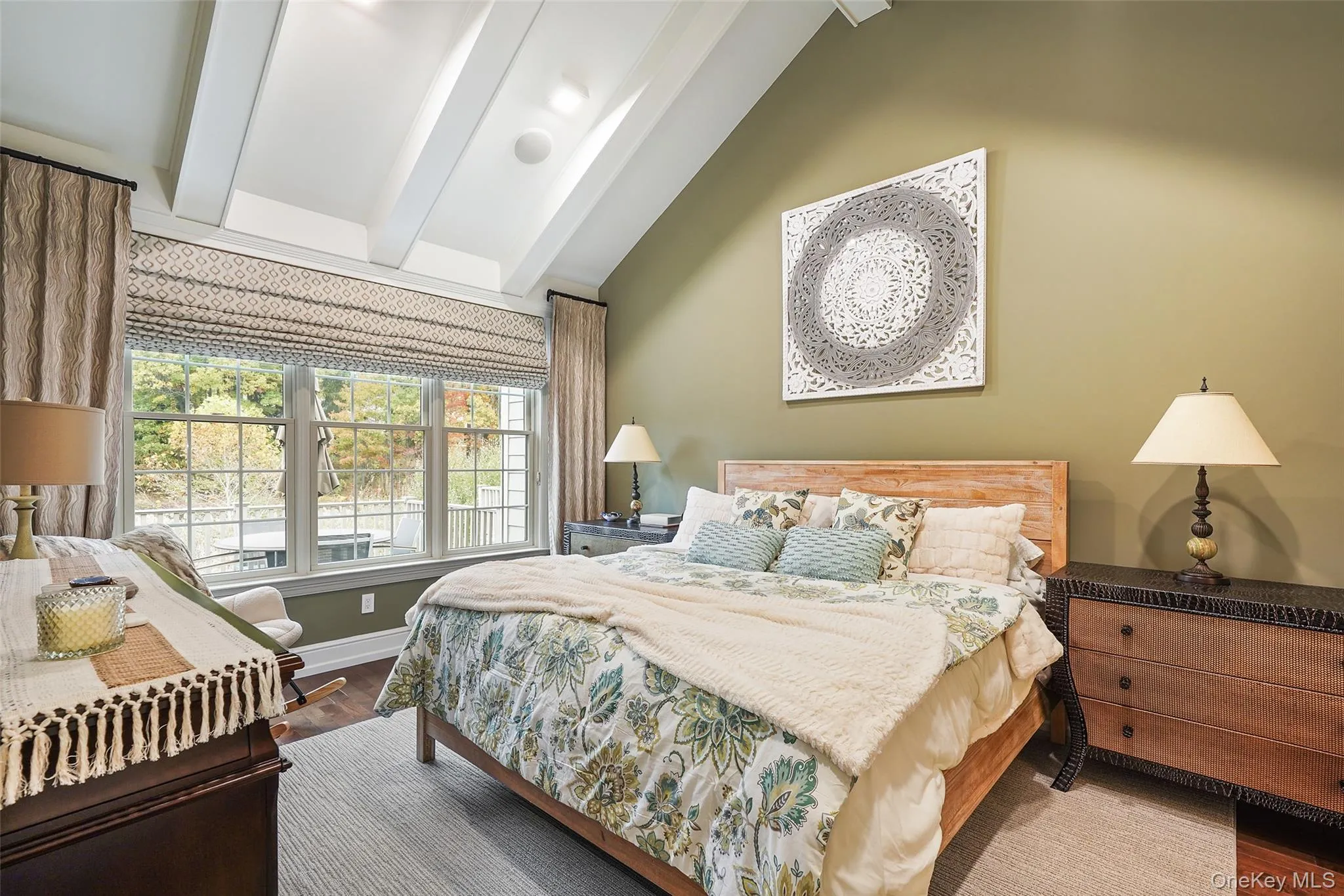 Bedroom featuring beam ceiling, dark wood-style flooring, and high vaulted ceiling Bedroom featuring beam ceiling, dark wood-style flooring, and high vaulted ceiling