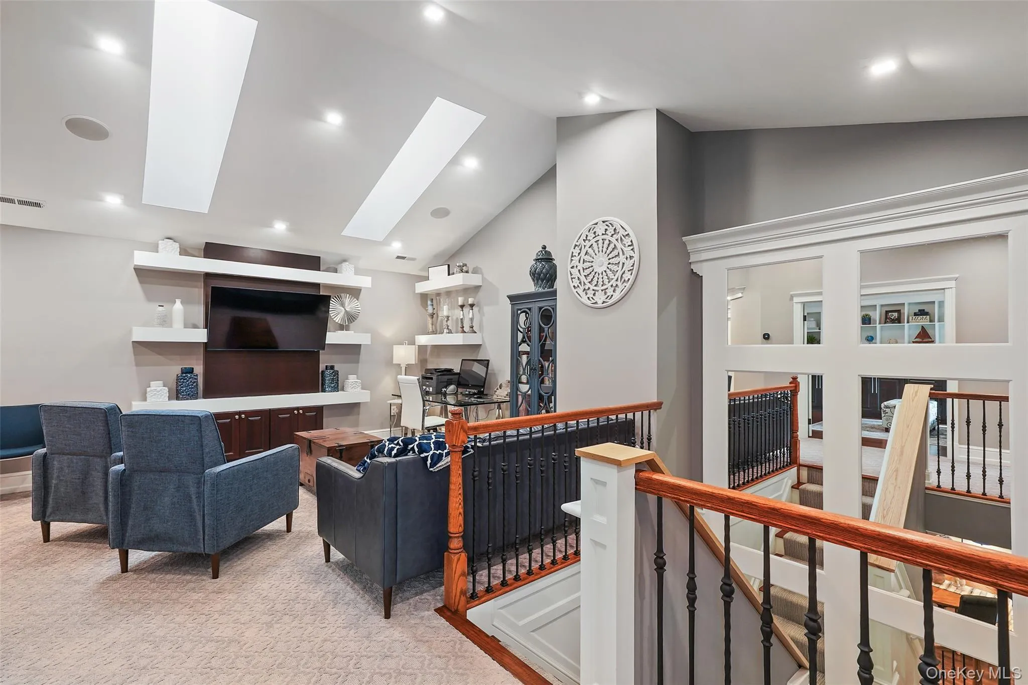 Living area featuring high vaulted ceiling, a skylight, light colored carpet, an office area, and recessed lighting Living area featuring high vaulted ceiling, a skylight, light colored carpet, an office area, and recessed lighting