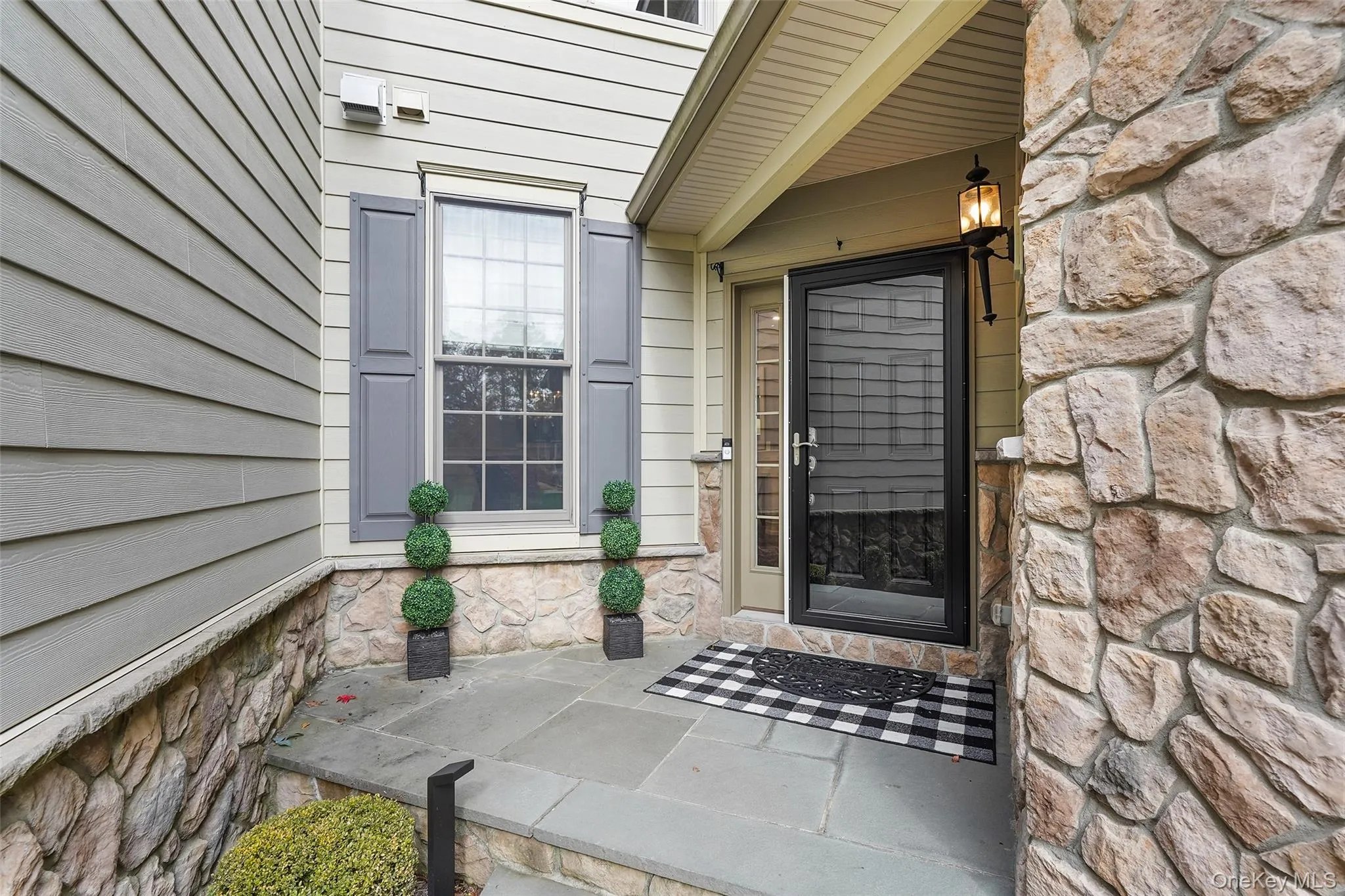 Property entrance with stone siding Property entrance with stone siding