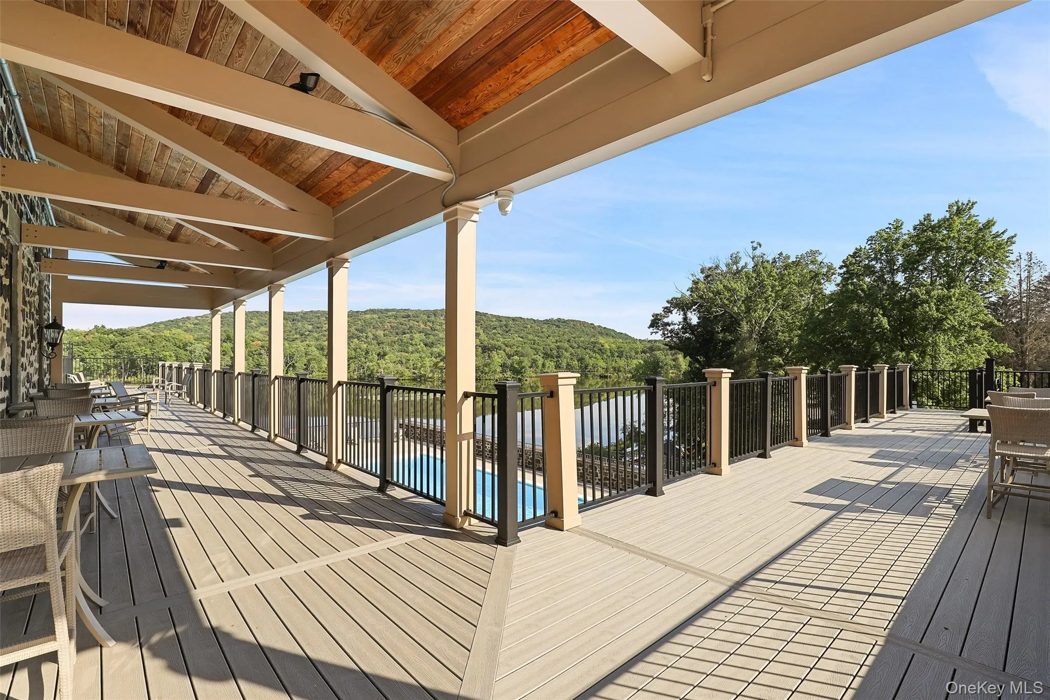 Wooden terrace with outdoor dining area and a forest view Wooden terrace with outdoor dining area and a forest view