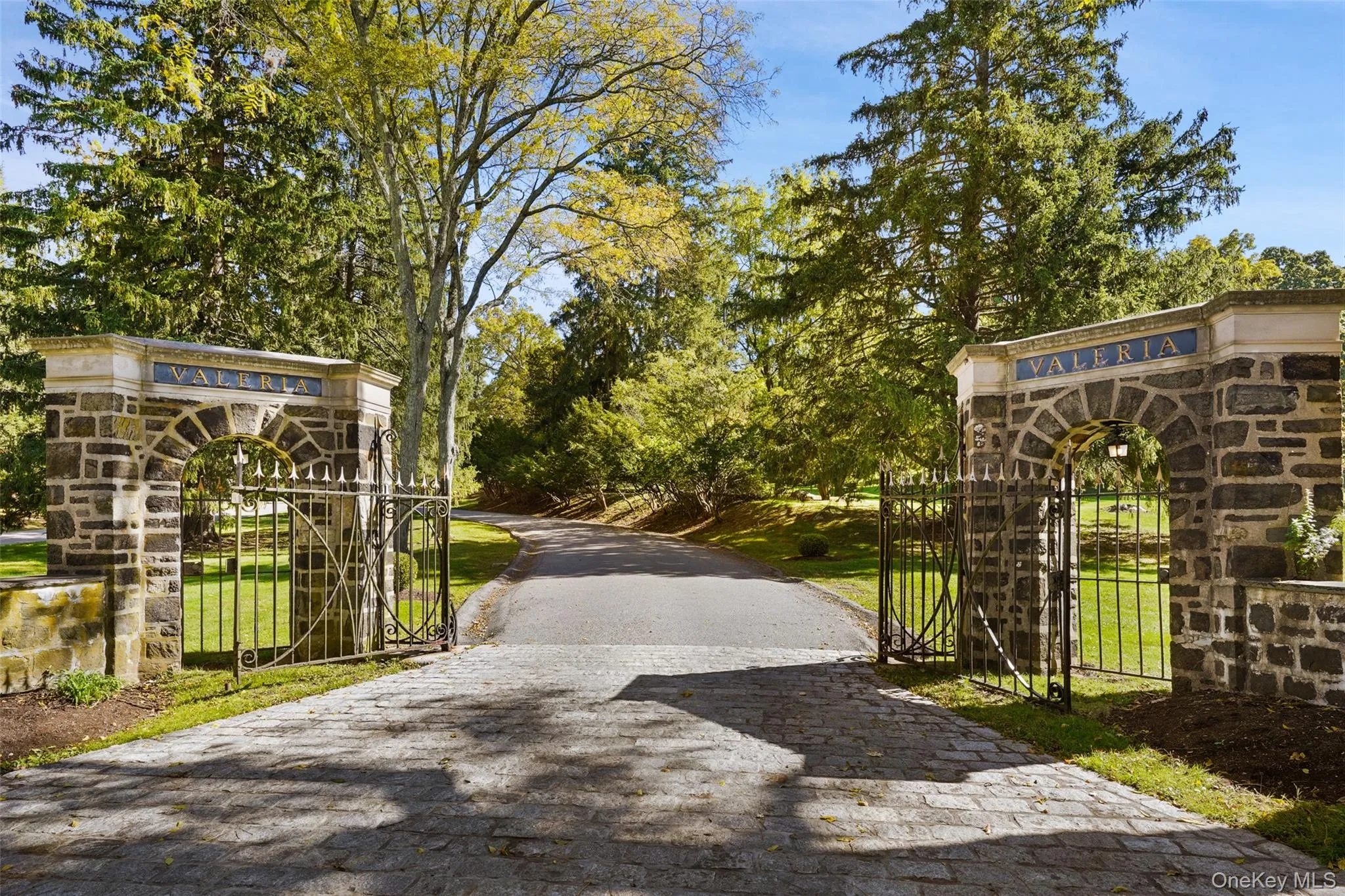 View of decorative driveway with a gate and a gated entry View of decorative driveway with a gate and a gated entry