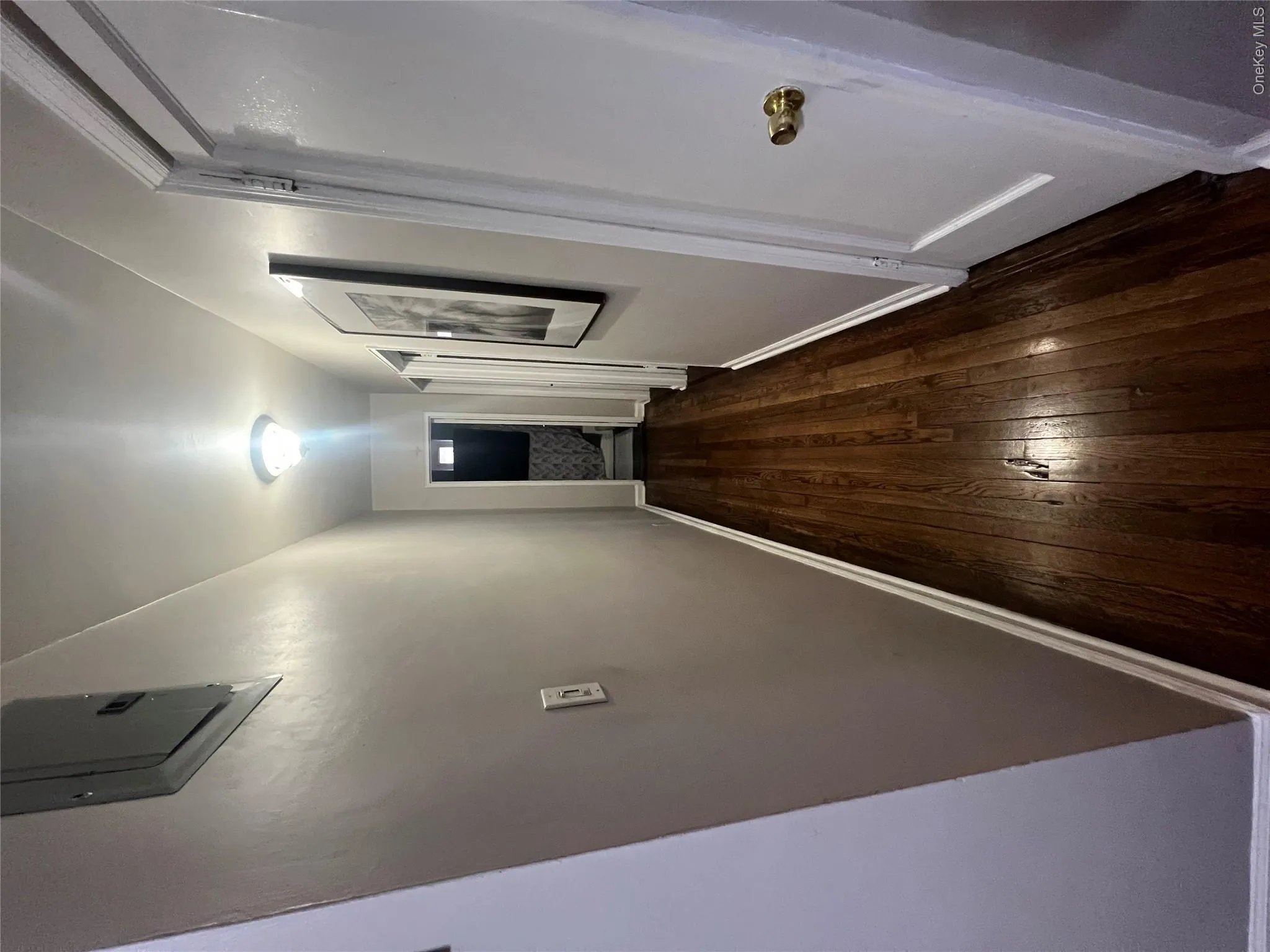 Corridor with hardwood / wood-style flooring and baseboards Corridor with hardwood / wood-style flooring and baseboards