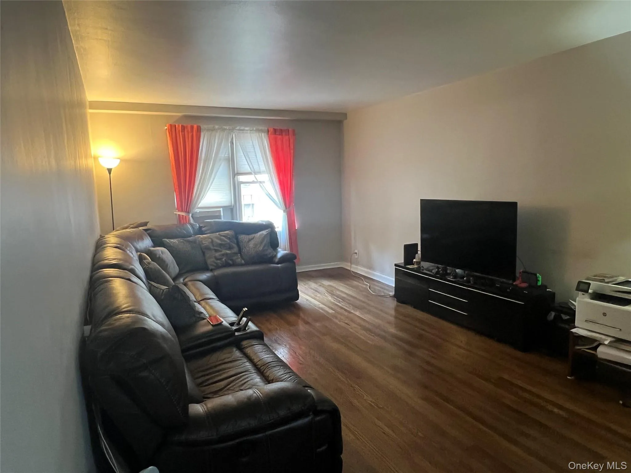 Living room featuring wood finished floors and baseboards Living room featuring wood finished floors and baseboards