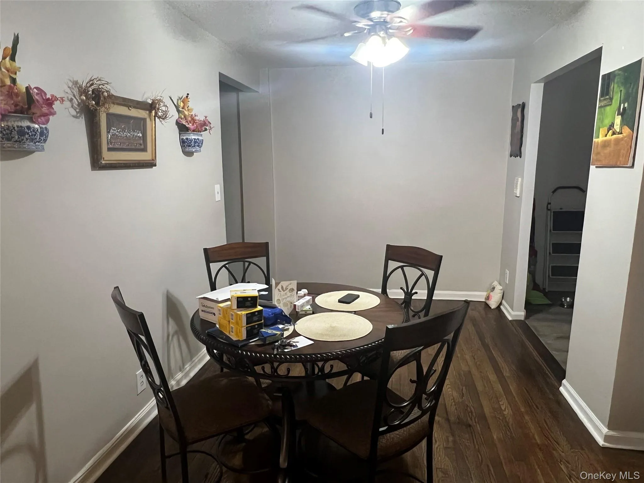 Dining room with wood finished floors, ceiling fan, and baseboards Dining room with wood finished floors, ceiling fan, and baseboards