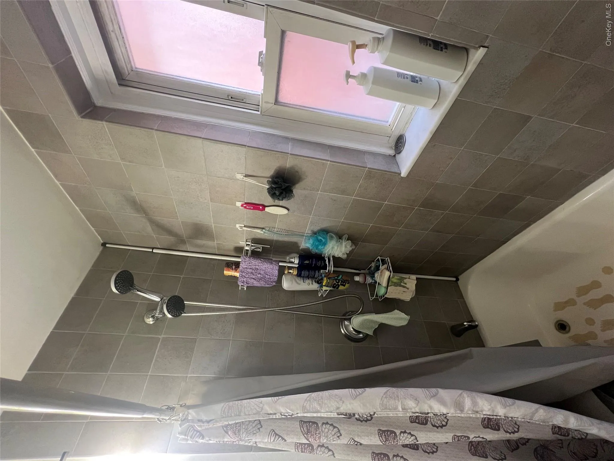 Full bathroom featuring shower / tub combo with curtain Full bathroom featuring shower / tub combo with curtain