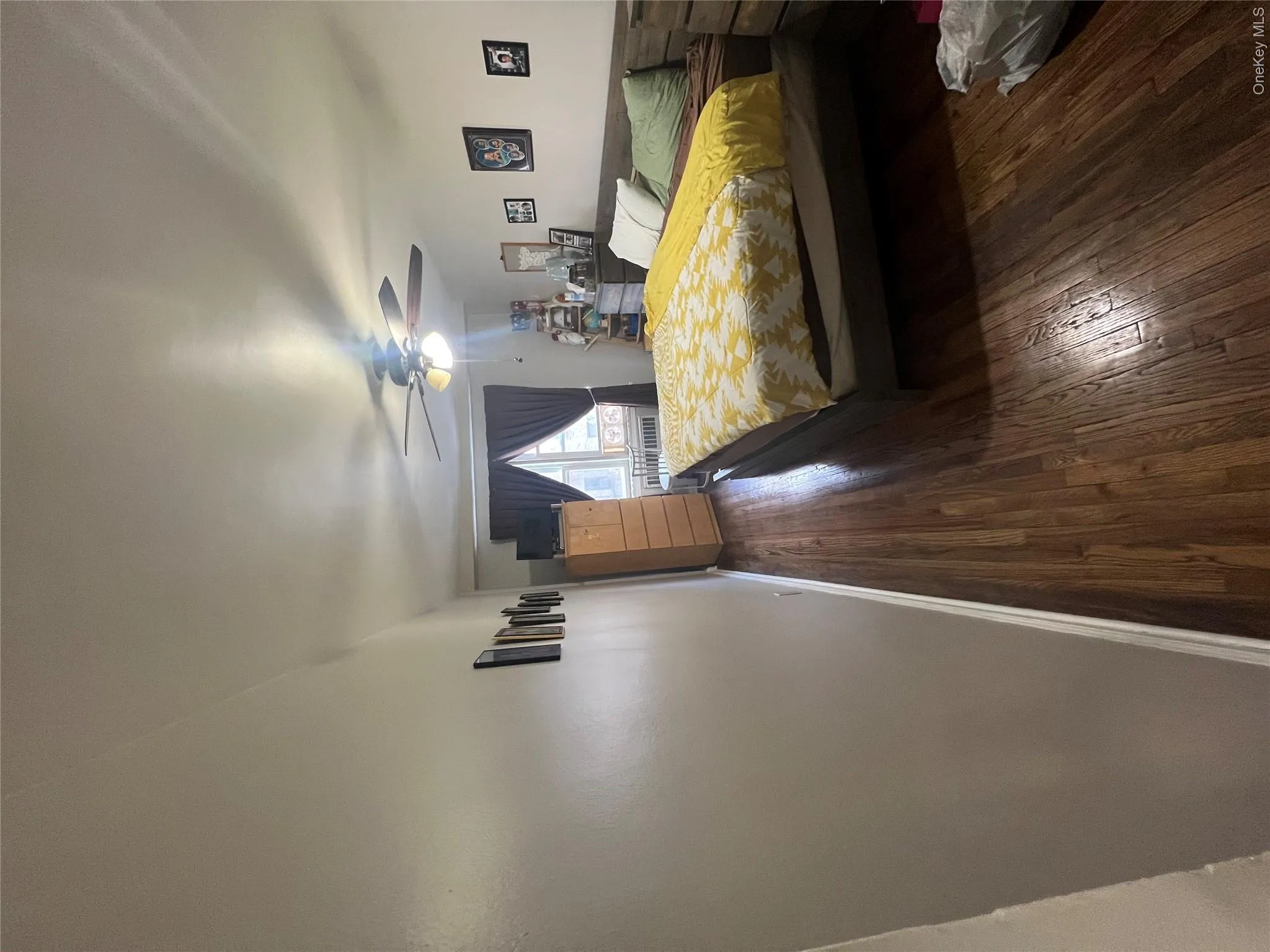 Bedroom with ceiling fan, baseboards, and dark wood finished floors Bedroom with ceiling fan, baseboards, and dark wood finished floors
