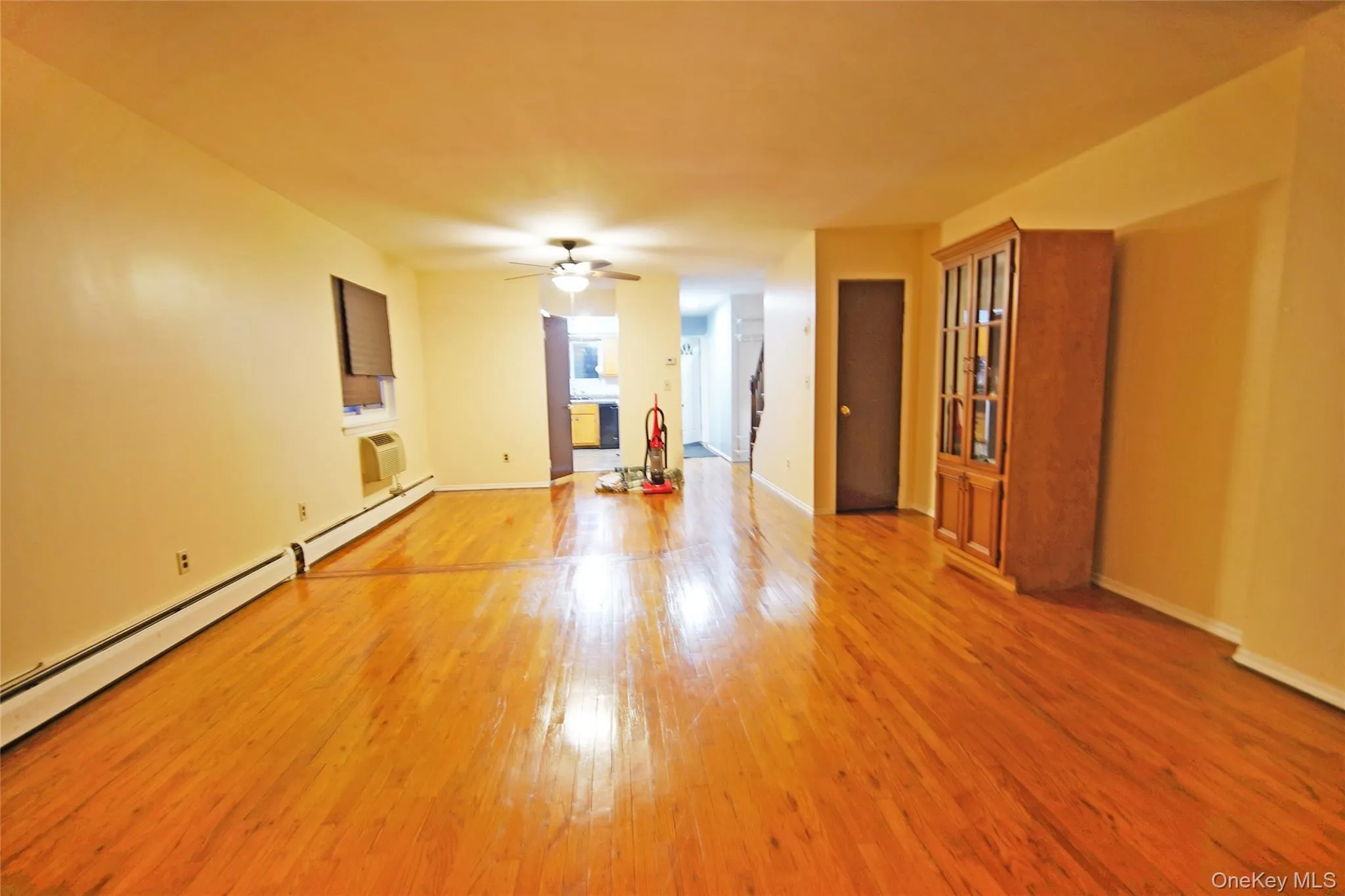 Spare room featuring light wood-style flooring, a baseboard heating unit, and ceiling fan Spare room featuring light wood-style flooring, a baseboard heating unit, and ceiling fan