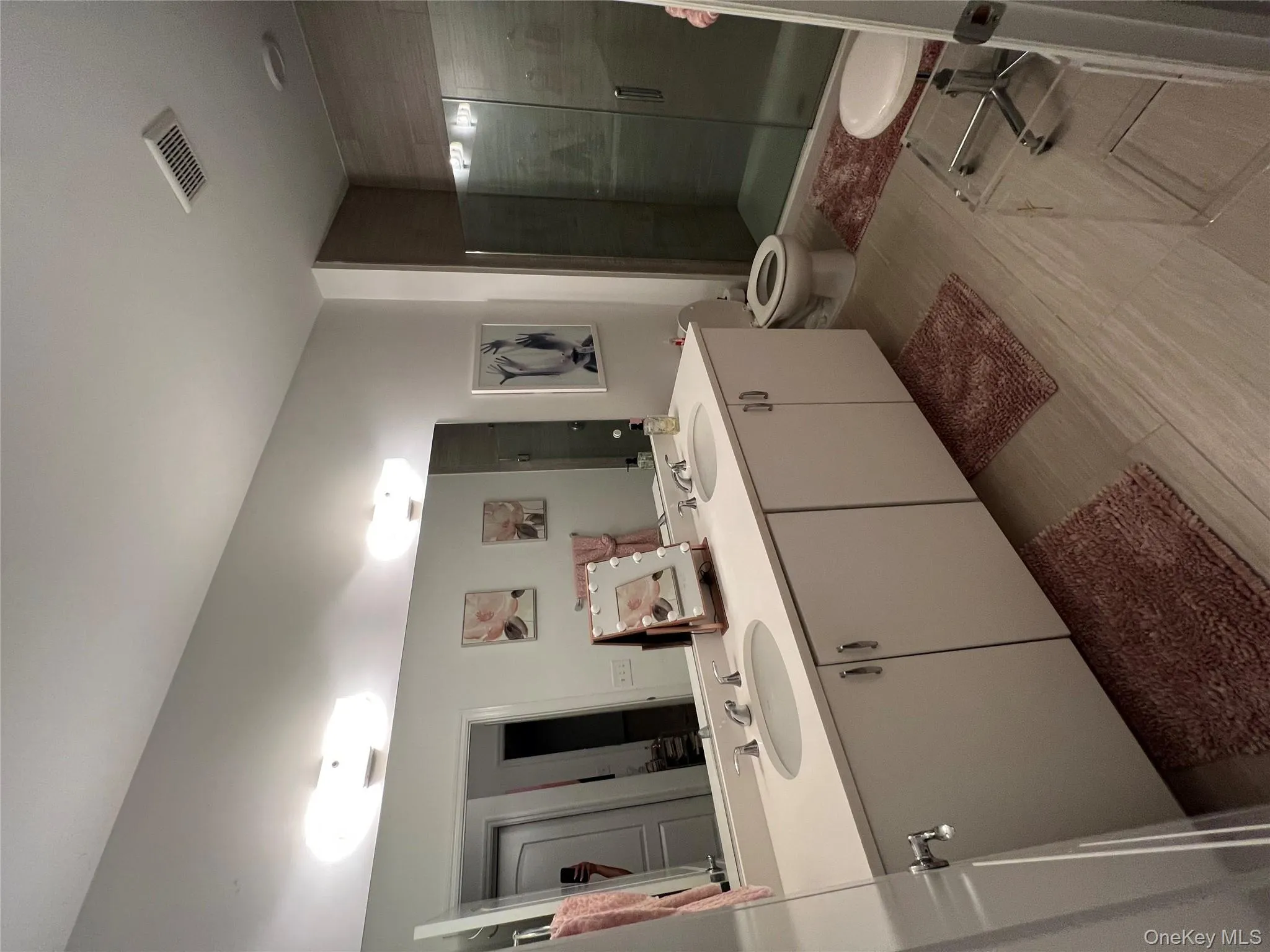 Bathroom featuring a shower stall and double vanity Bathroom featuring a shower stall and double vanity