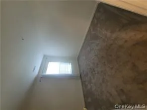 Unfurnished room with dark carpet and baseboards Unfurnished room with dark carpet and baseboards