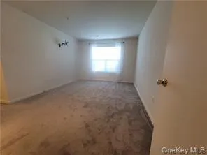 Unfurnished room featuring carpet floors and baseboards Unfurnished room featuring carpet floors and baseboards