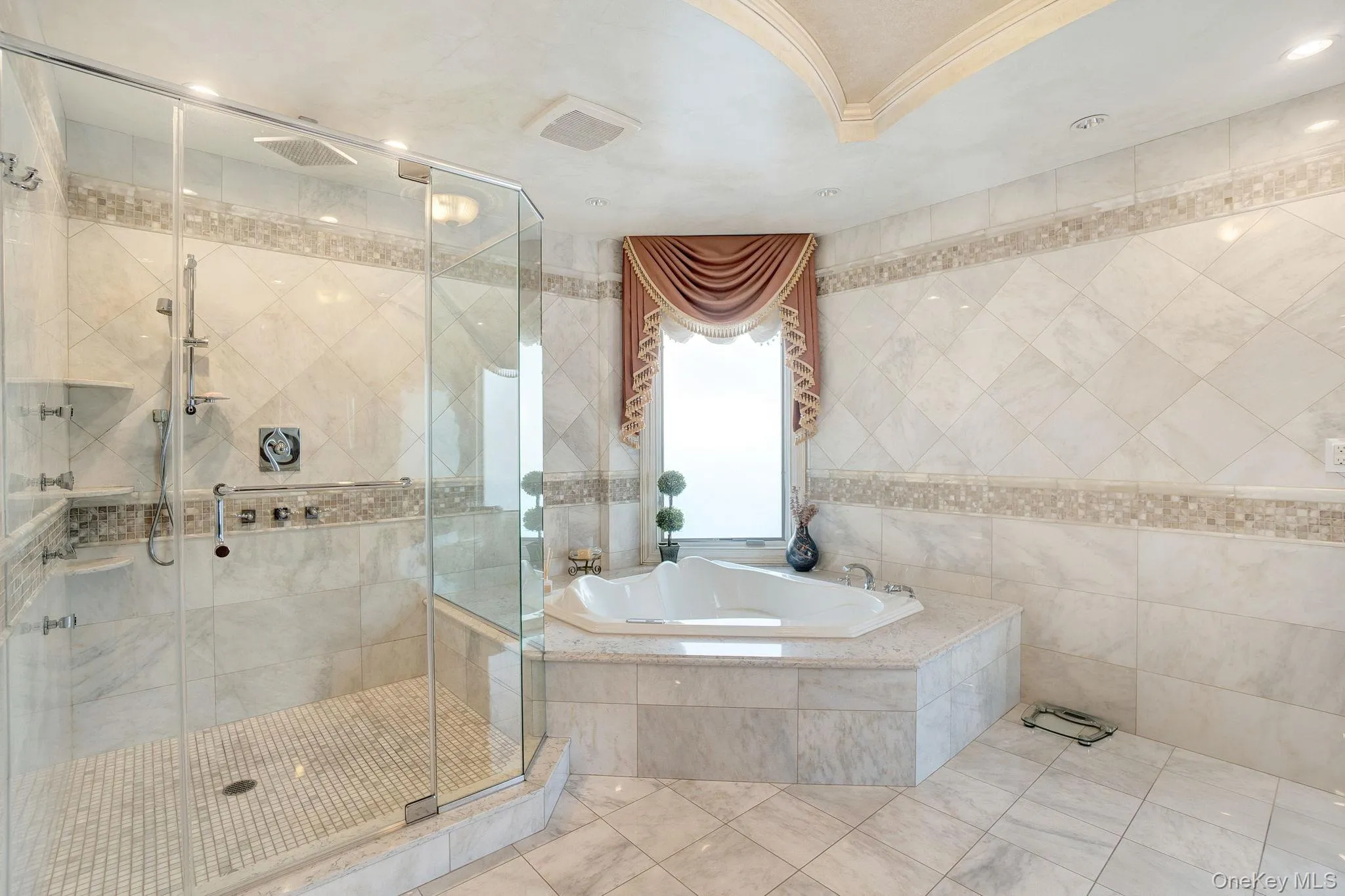 Full bathroom featuring a shower stall, tile walls, a garden tub, tile patterned flooring, and crown molding Full bathroom featuring a shower stall, tile walls, a garden tub, tile patterned flooring, and crown molding