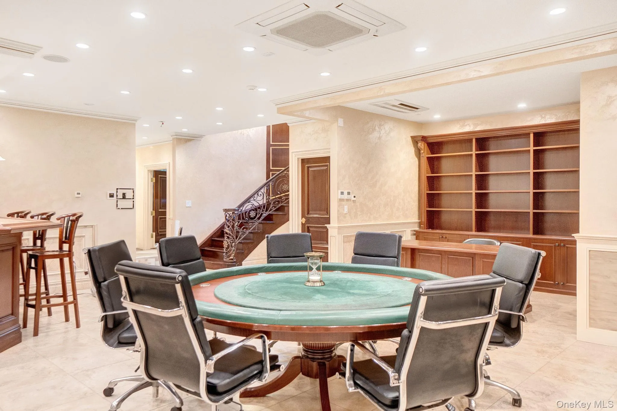 Rec room featuring recessed lighting, wainscoting, and a decorative wall Rec room featuring recessed lighting, wainscoting, and a decorative wall