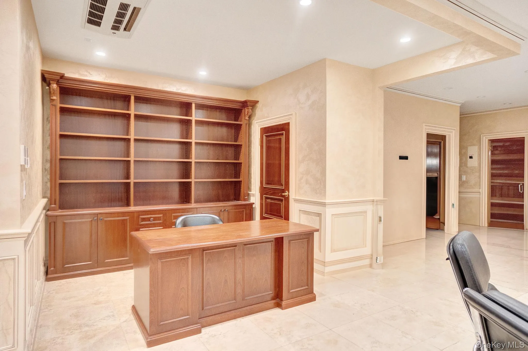 Unfurnished office featuring a decorative wall, wainscoting, recessed lighting, and light tile patterned flooring Unfurnished office featuring a decorative wall, wainscoting, recessed lighting, and light tile patterned flooring