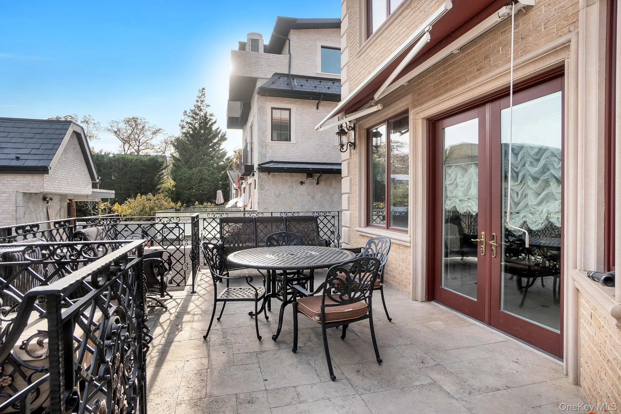 Balcony with french doors and outdoor dining area Balcony with french doors and outdoor dining area