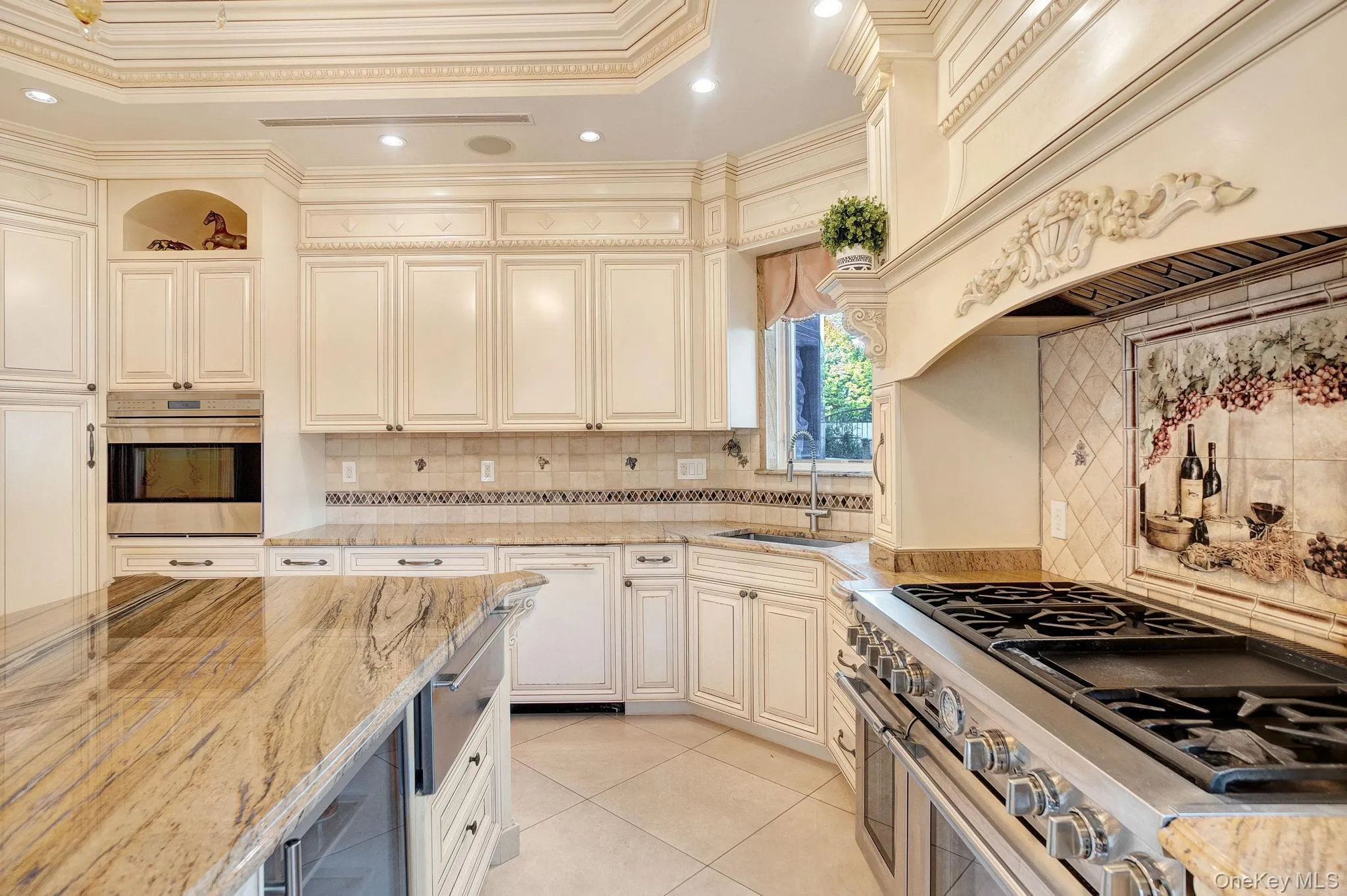Kitchen featuring backsplash, light stone countertops, stainless steel appliances, crown molding, and recessed lighting Kitchen featuring backsplash, light stone countertops, stainless steel appliances, crown molding, and recessed lighting
