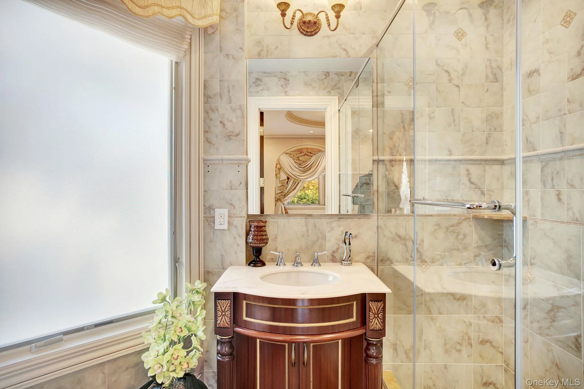 Full bath with tile walls, vanity, a shower stall, and backsplash Full bath with tile walls, vanity, a shower stall, and backsplash