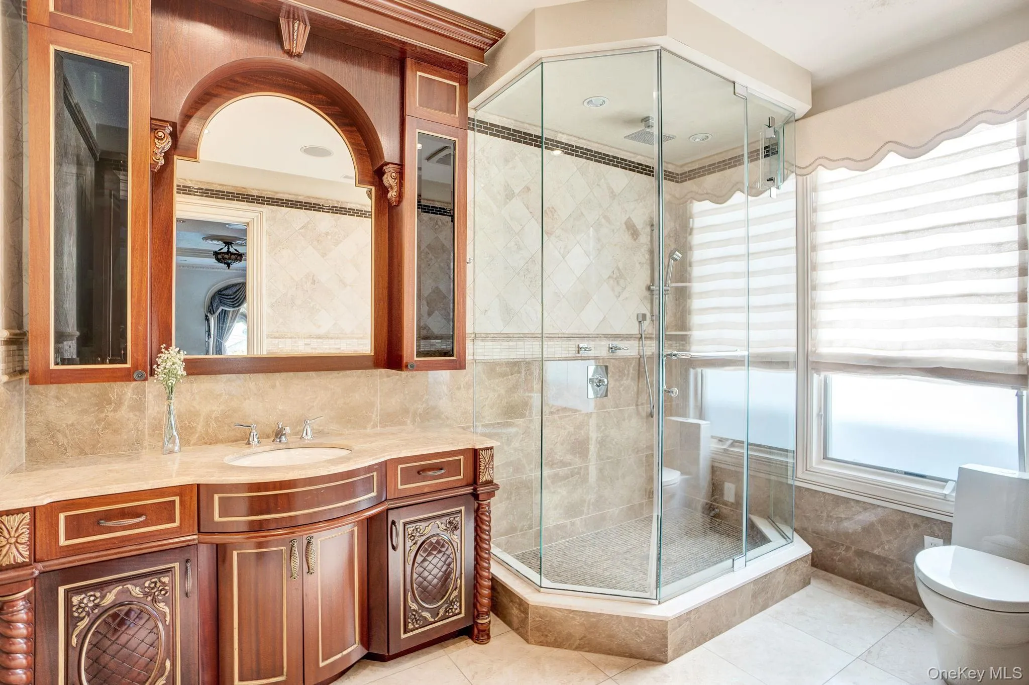 Bathroom with vanity, light tile patterned floors, tile walls, a shower stall, and tasteful backsplash Bathroom with vanity, light tile patterned floors, tile walls, a shower stall, and tasteful backsplash