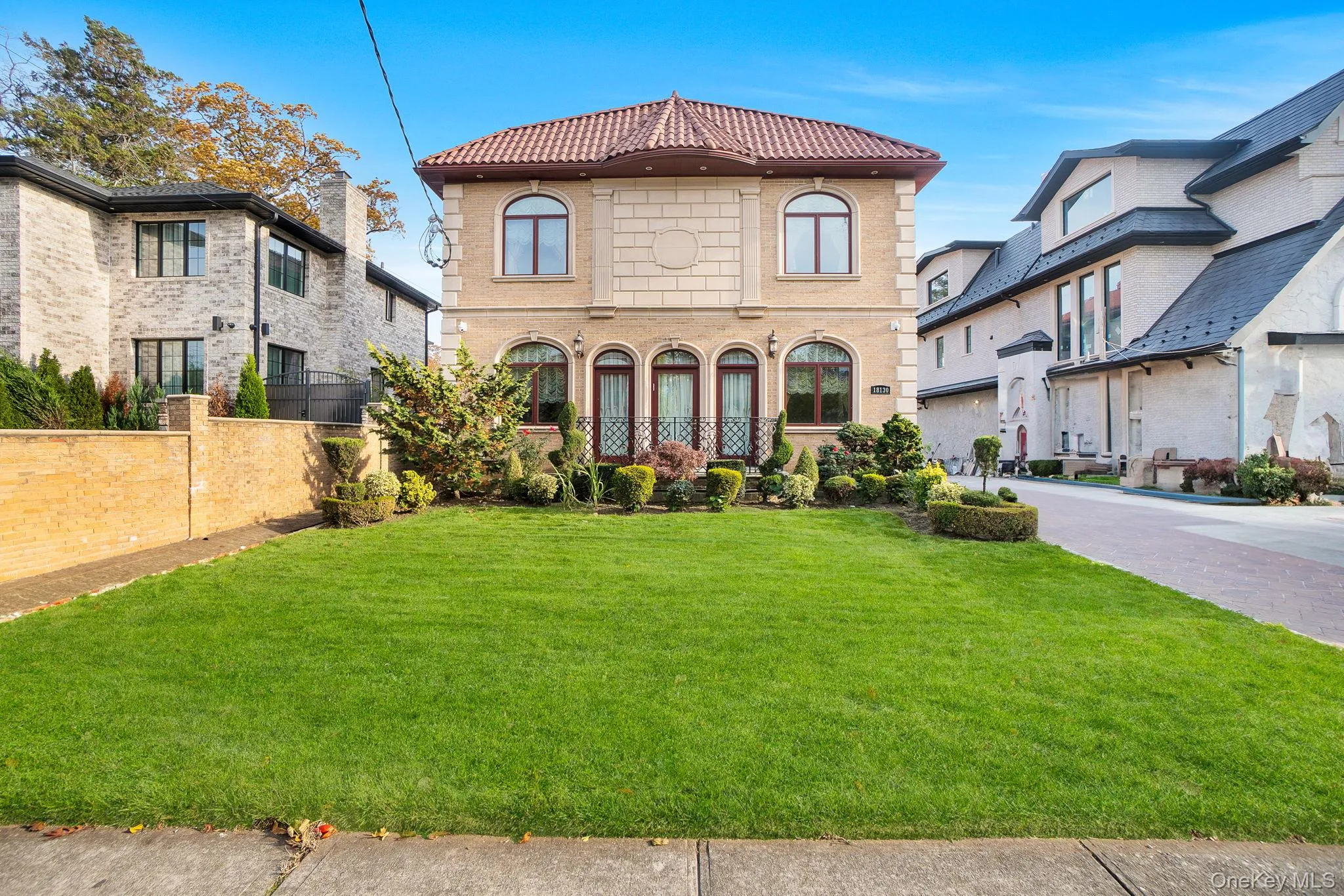 View of front facade featuring a tiled roof and driveway View of front facade featuring a tiled roof and driveway