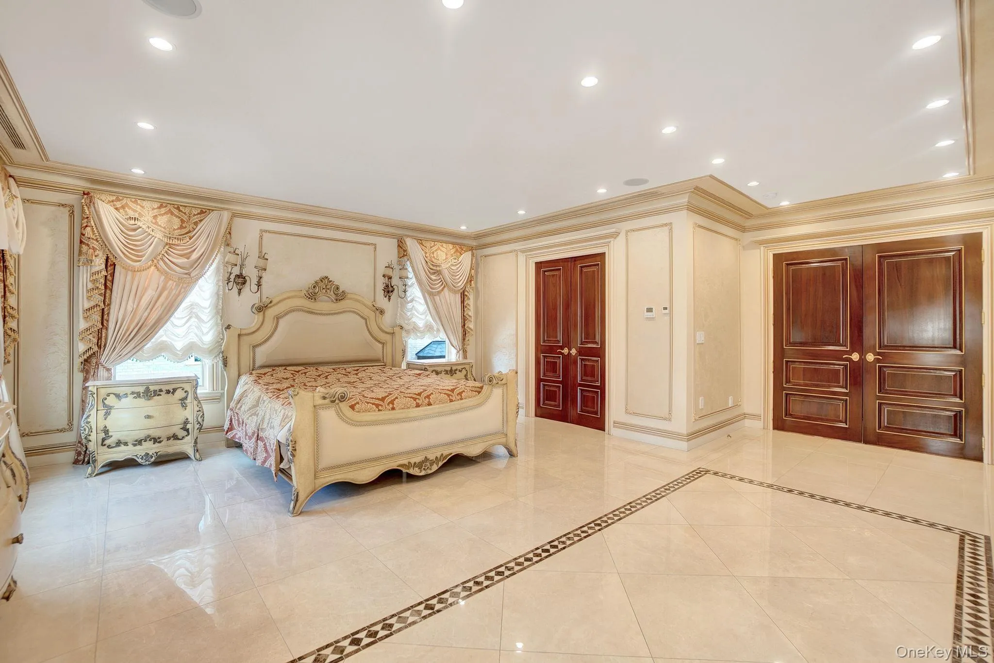 Bedroom featuring crown molding, recessed lighting, light tile patterned floors, and inlaid floor details Bedroom featuring crown molding, recessed lighting, light tile patterned floors, and inlaid floor details