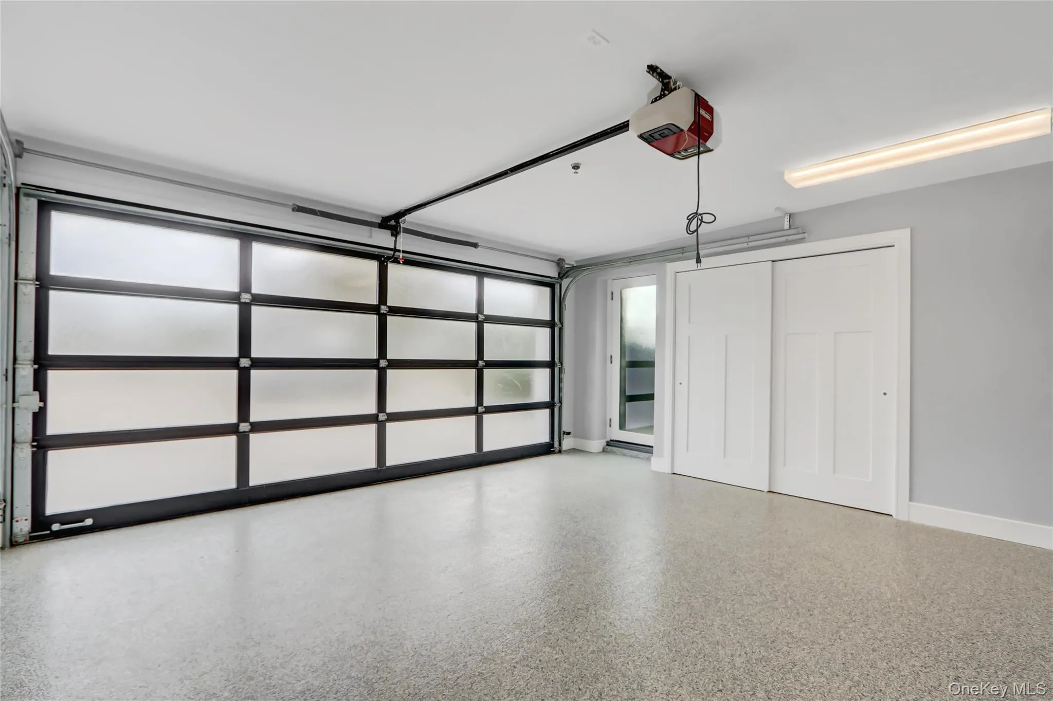 2 car Garage with a garage door opener and baseboards 2 car Garage with a garage door opener and baseboards