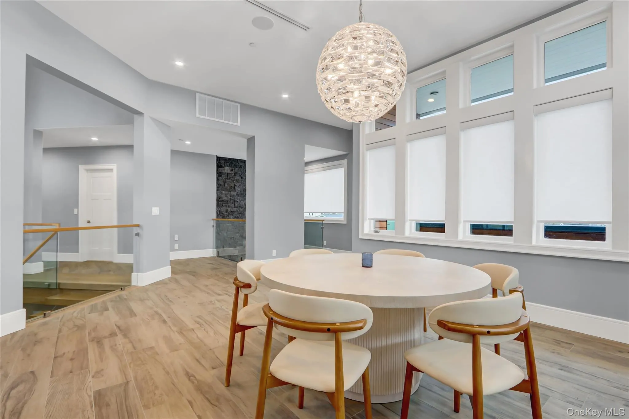 Dining room with light wood finished floors, plenty of natural light, a chandelier, and recessed lighting Dining room with light wood finished floors, plenty of natural light, a chandelier, and recessed lighting
