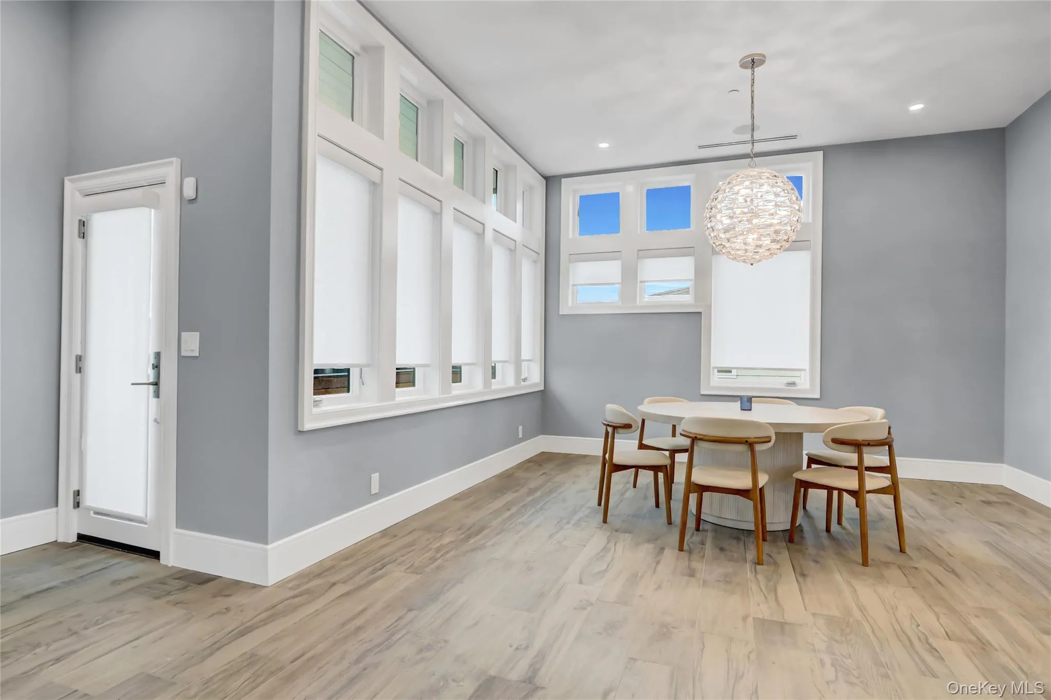 Dining room with light wood-style flooring and a chandelier Dining room with light wood-style flooring and a chandelier