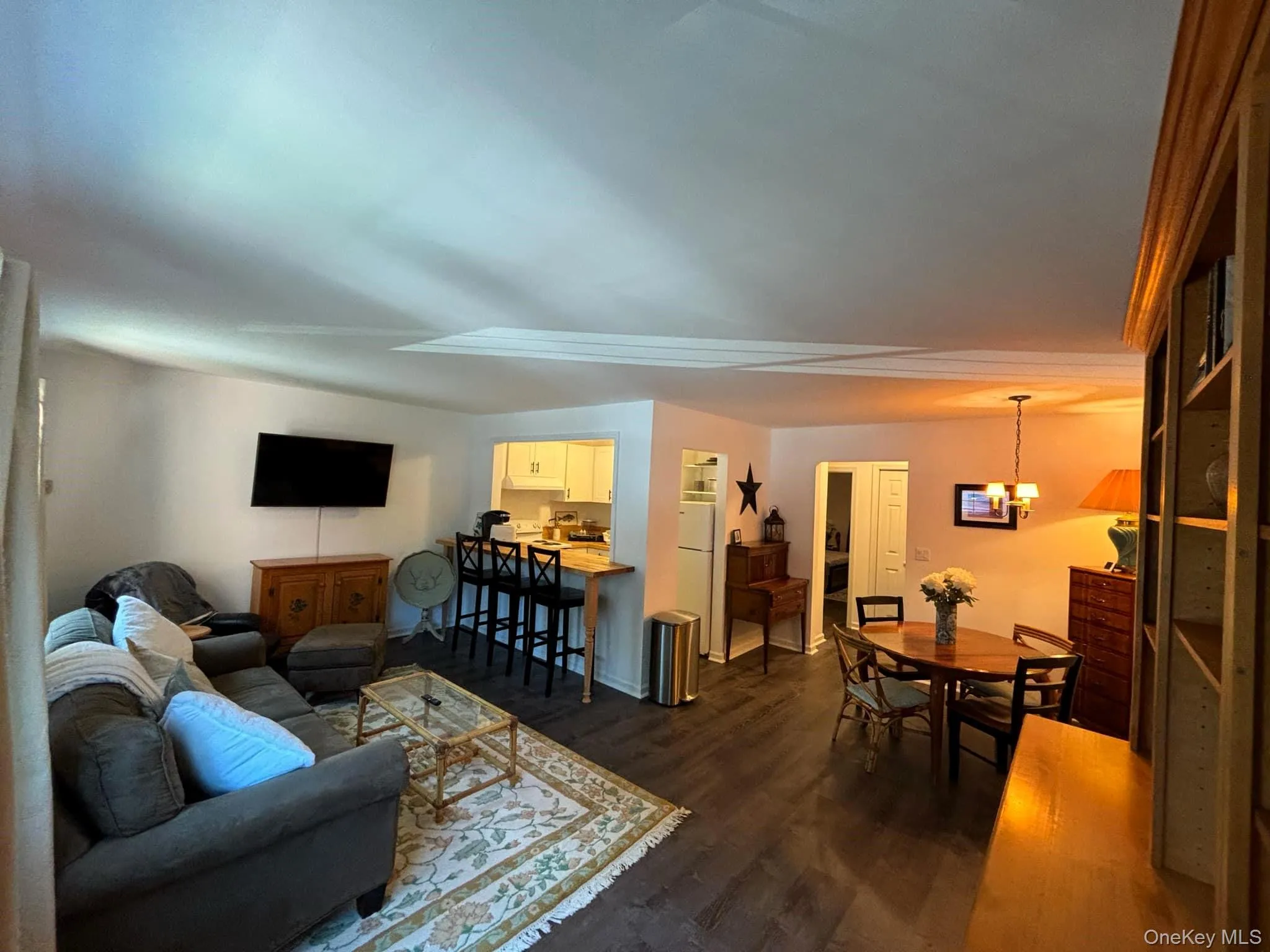 Living area with dark wood-type flooring and a chandelier Living area with dark wood-type flooring and a chandelier